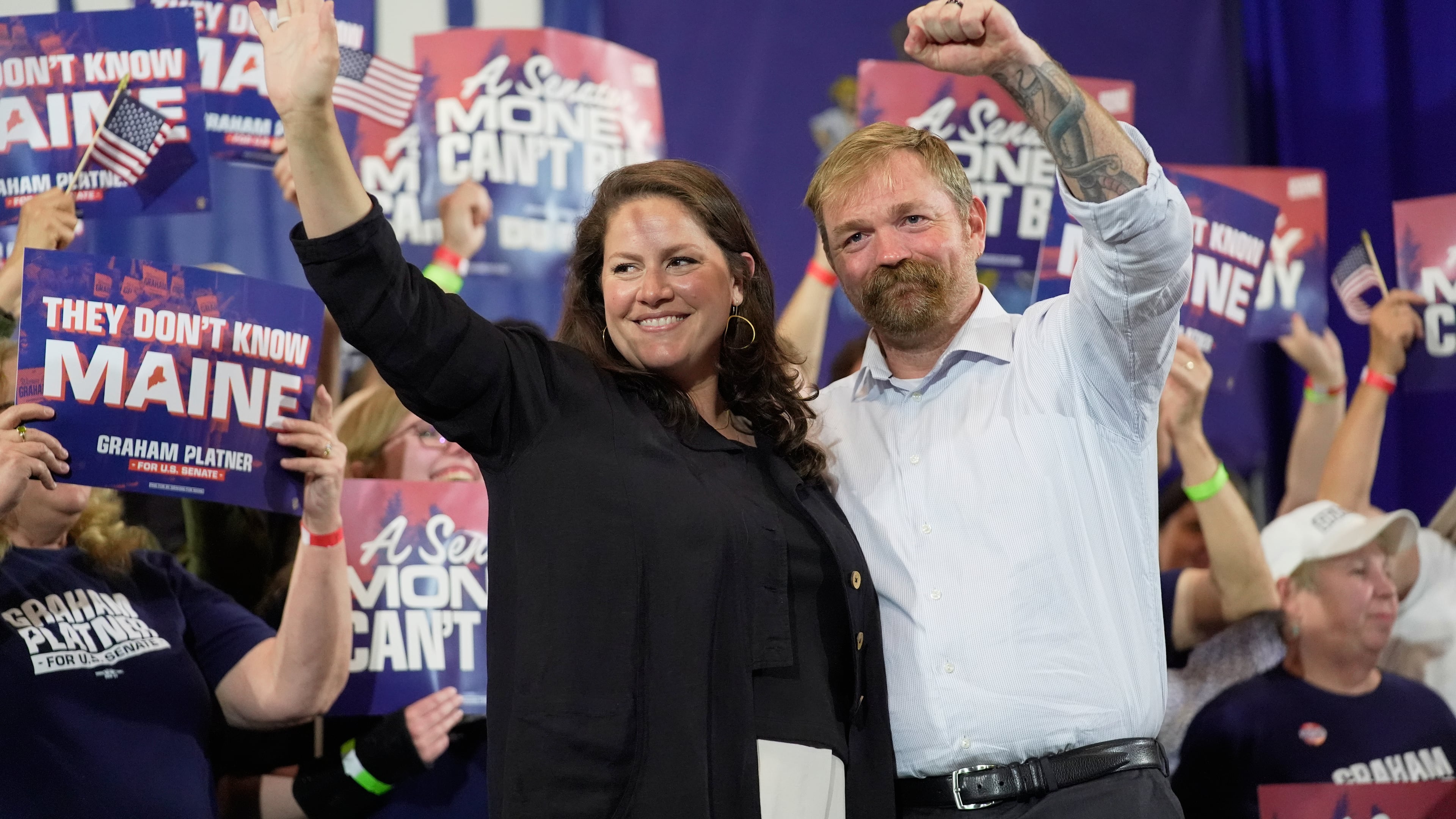 Democratic U.S. Senate candidate Graham Platner, right, and his wife Amy Gertner gesture to supporters during a primary election night watch party Tuesday, June 9, 2026, in Blue Hill, Maine. (AP Photo/Robert F. Bukaty)