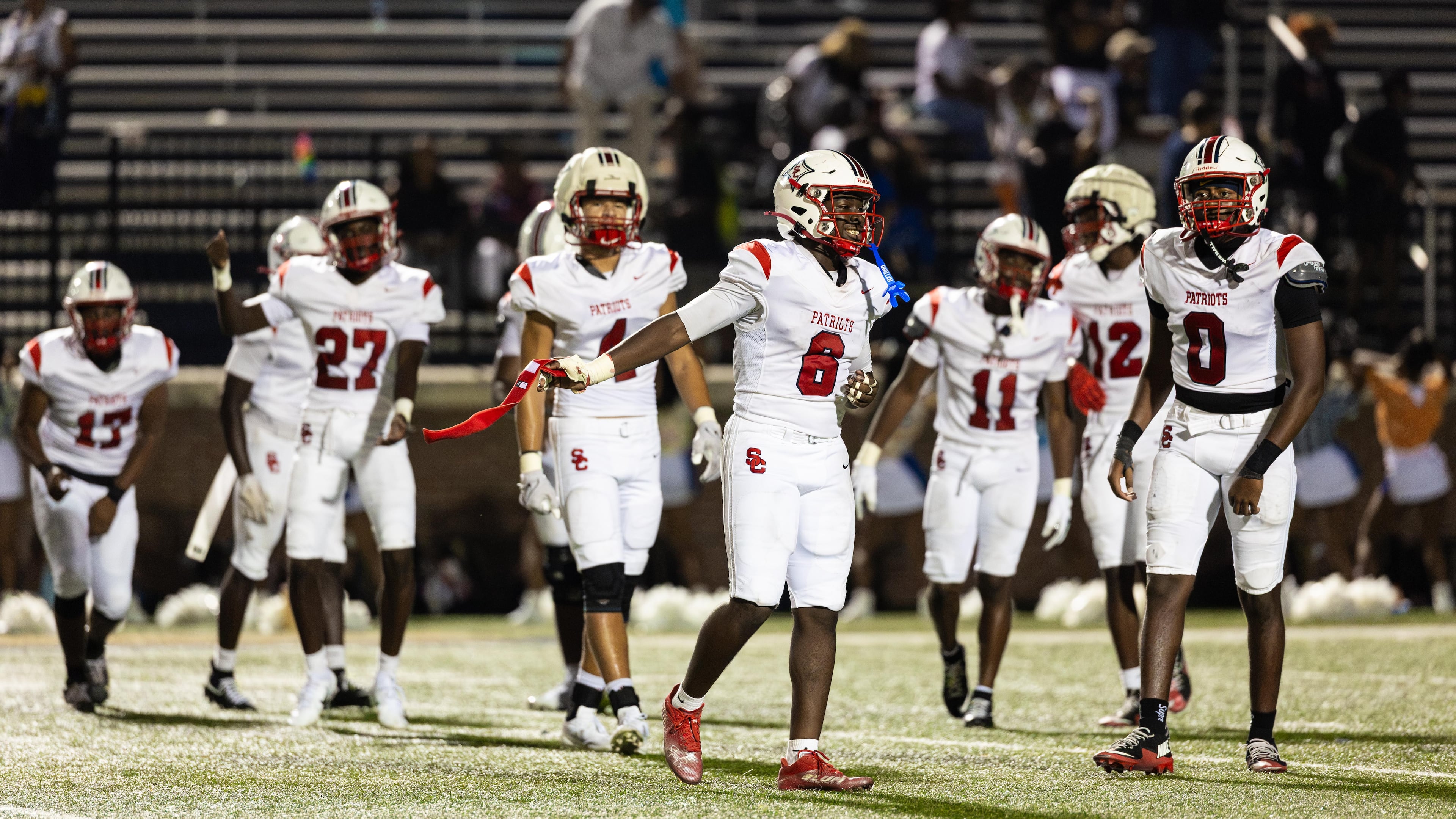 Sandy Creek linebacker Elijah Ware (front) and teammates celebrate their victory over Douglas County on Friday, Aug. 28, 2026, at Douglas County High School. (Oscar Guevara Saenz for the AJC)