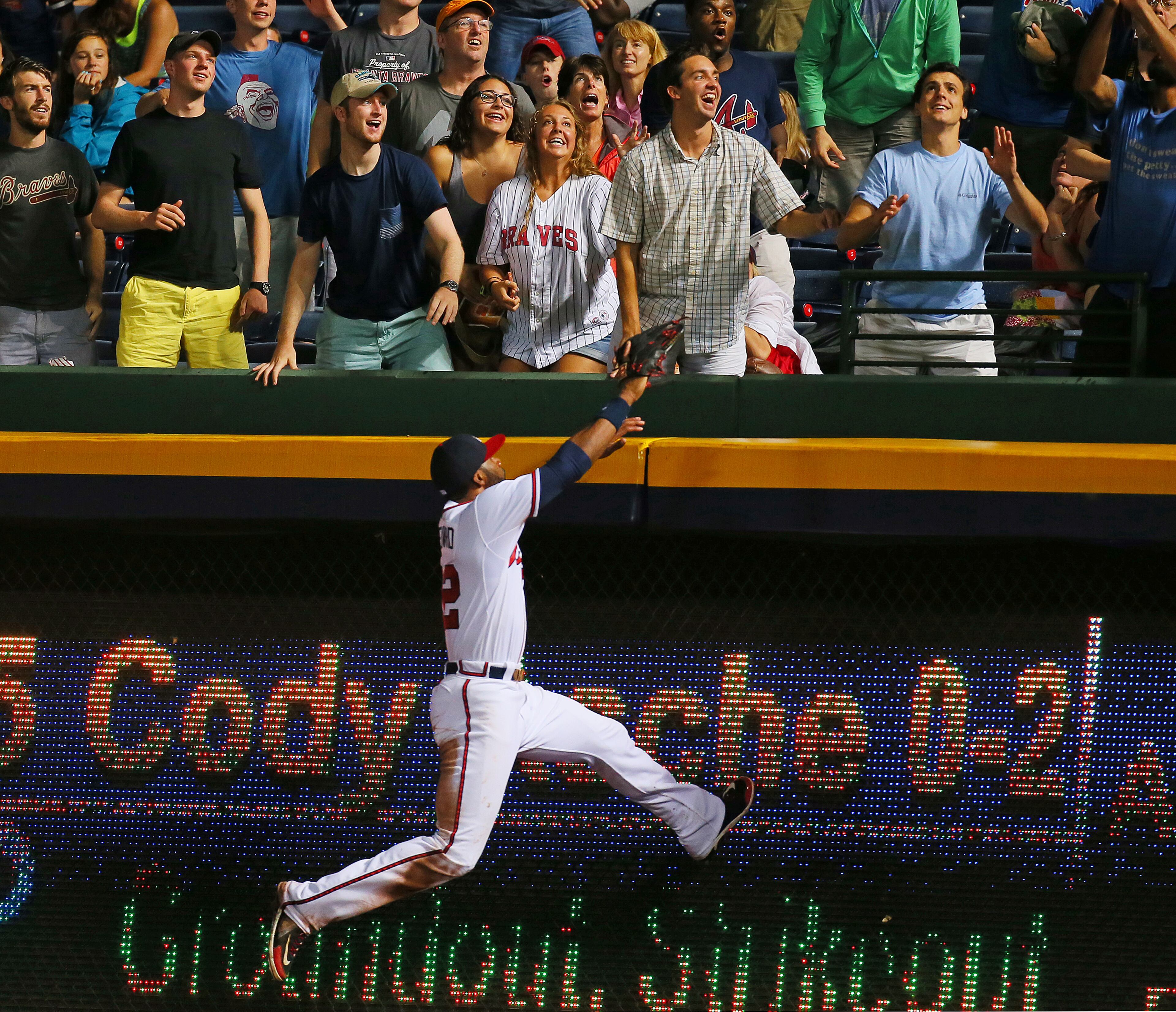 Braves outfielder Jason Heyward can't reach a 3-RBI home run by Phillies Cody Asche for a 4-0 lead over the Braves during the 6th inning.