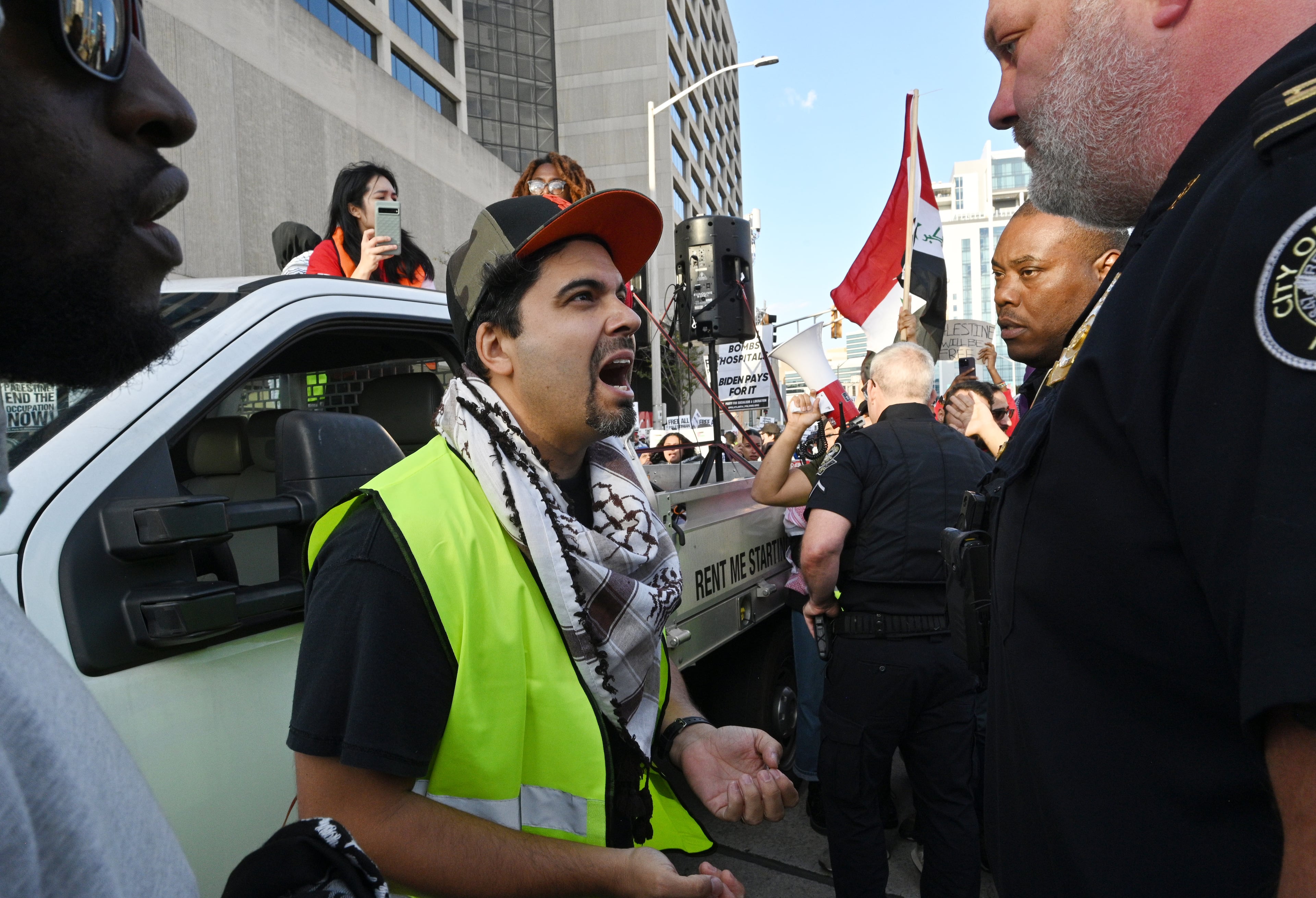 A pro-Palestinian supporter confronts police officers as they block traffic to begin marching during a rally in front of the CNN Center, Friday, October 20, 2023, in Atlanta. Hundreds gathered in downtown Atlanta to march in support of Palestine. (Hyosub Shin / Hyosub.Shin@ajc.com)
