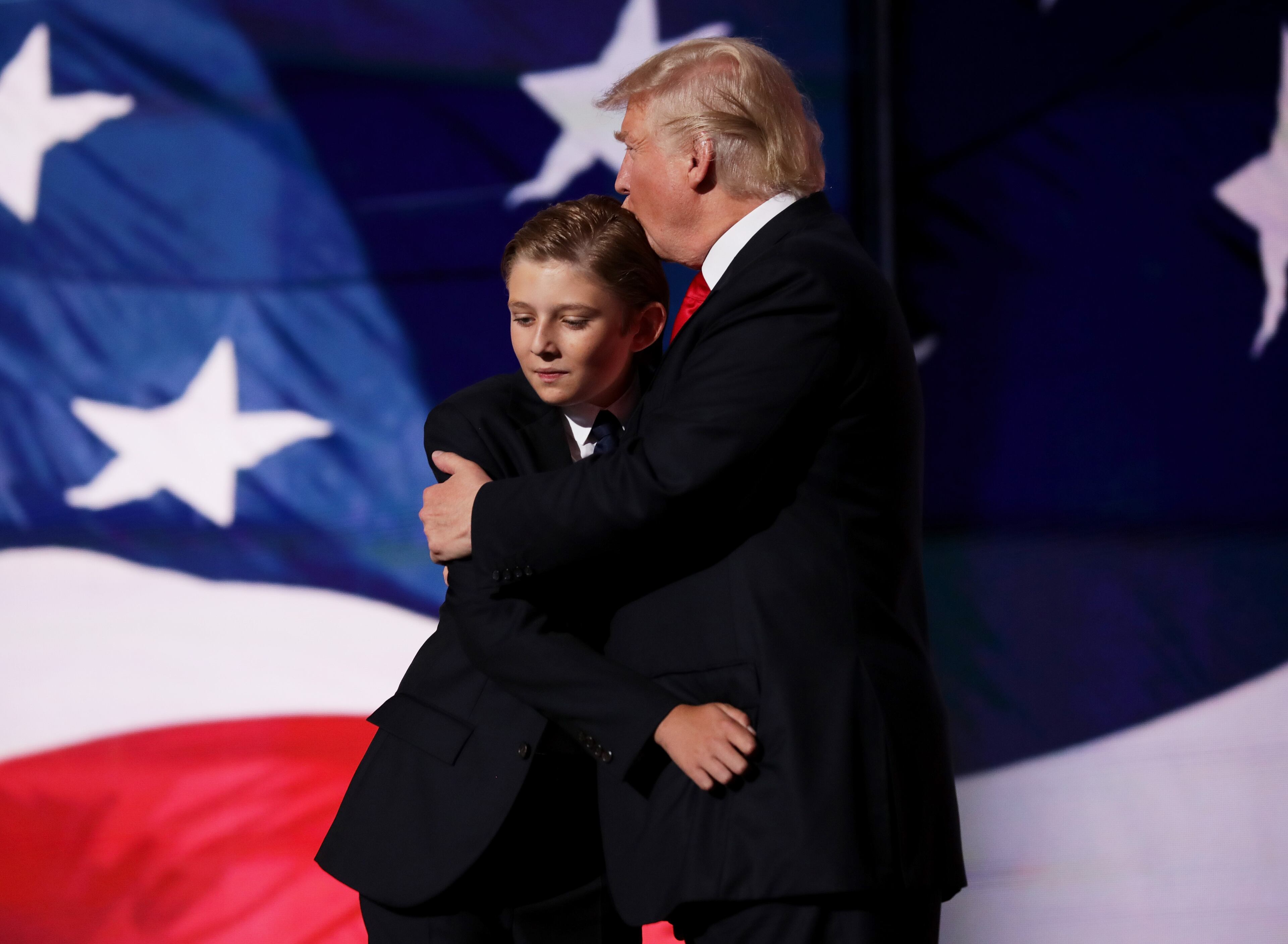 Republican presidential candidate Donald embraces his son Barron Trump after he delivered his speech on the fourth day of the Republican National Convention on July 21, 2016, at the Quicken Loans Arena in Cleveland, Ohio. (Photo by Chip Somodevilla/Getty Images)