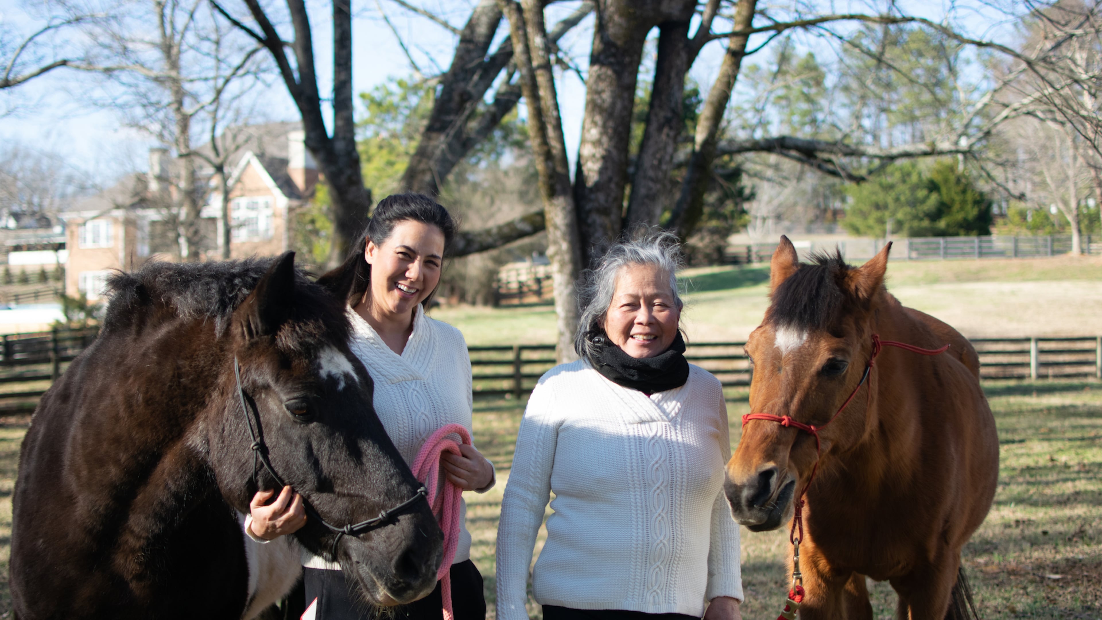 Joy Lim Narkin with draft horse rescue, Geronimo and her mother, Teresita Lim King, with senior rescue horse, Arabella at Joyous Acres. (Courtesy Joy Narkin)