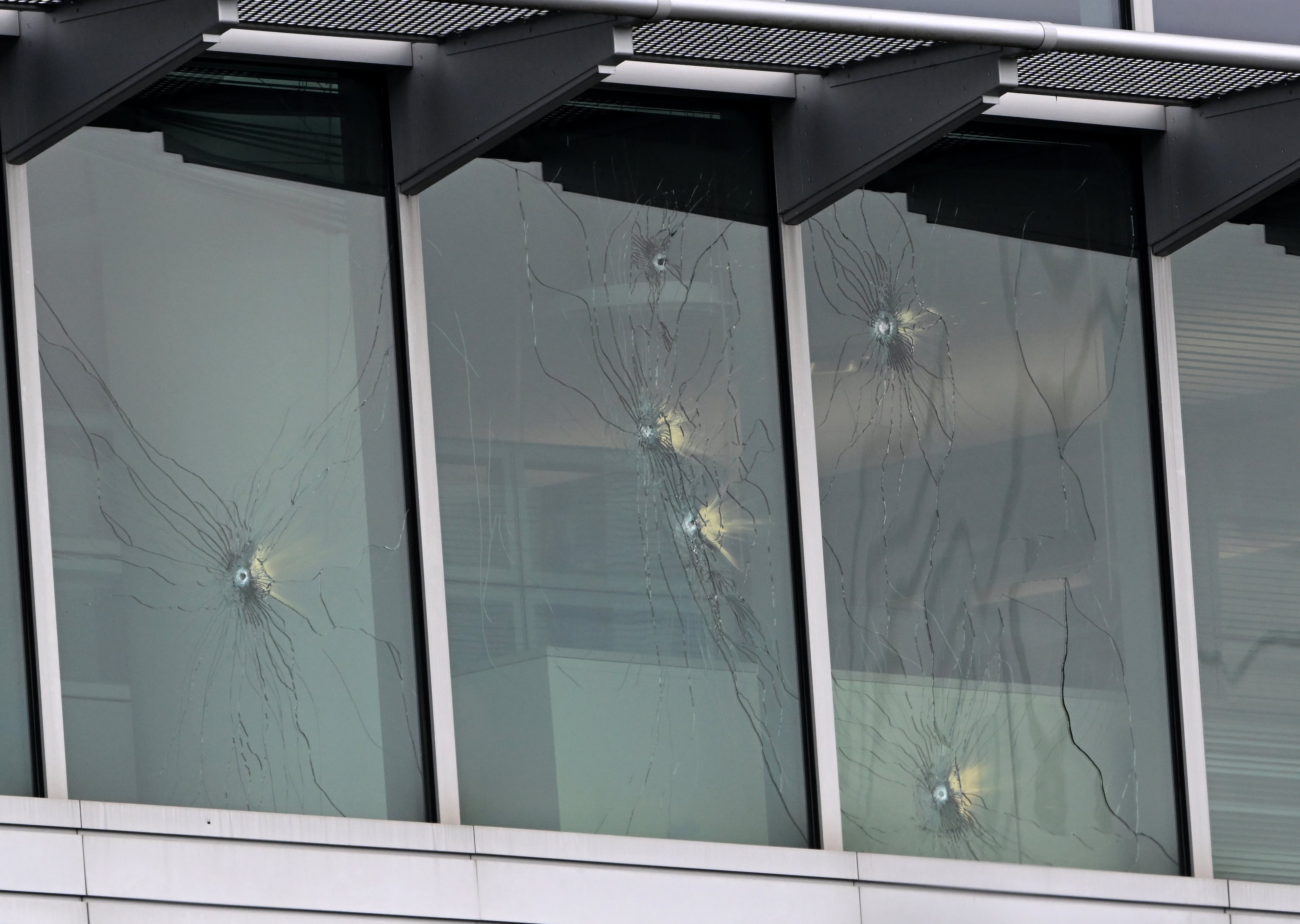 Bullet holes are visible in a CDC building on Aug. 9, 2025, after a deadly shooting Friday. A man opened fire on the Centers for Disease Control and Prevention, killing a police officer who tried to stop him. (Hyosub Shin/AJC)