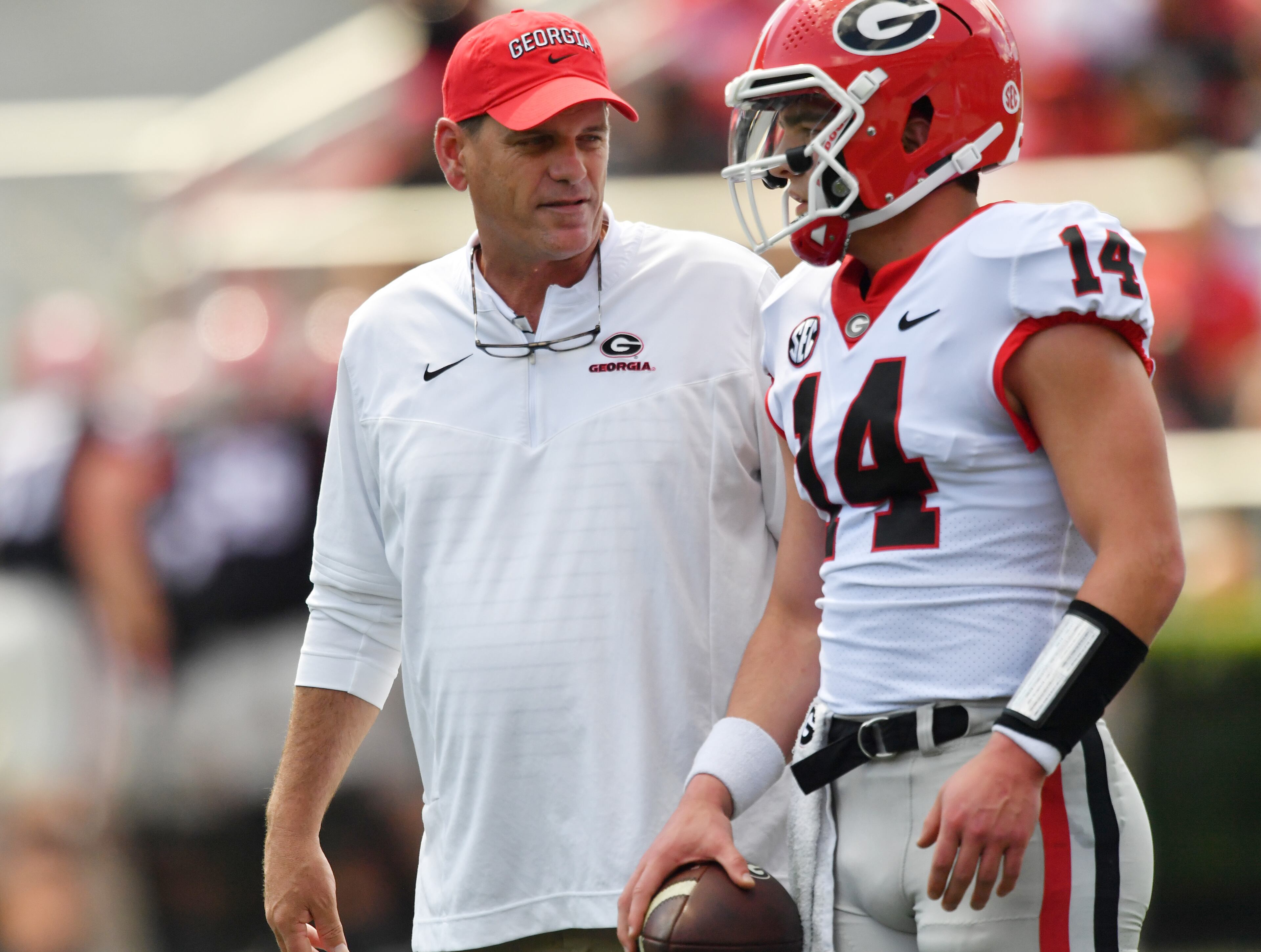 Offensive Coordinator Mike Bobo talks to Georgia's quarterback Gunner Stockton (14) before the G - Day game at Sanford Stadium, Saturday, April 15, 2023, in Athens. (Hyosub Shin / Hyosub.Shin@ajc.com)
