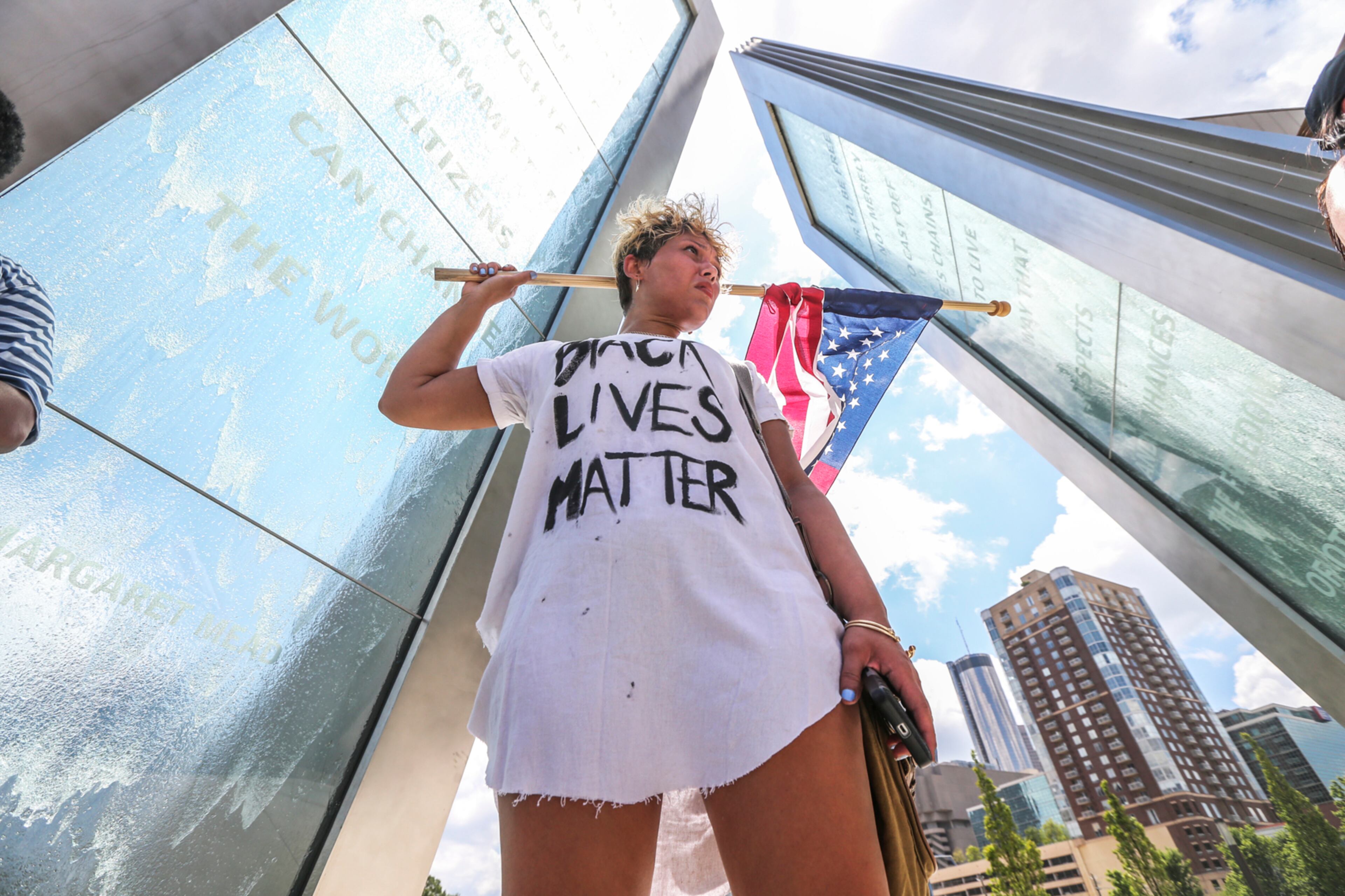 July 8, 2016 Atlanta: Sarah Golden protests at the National Center for Civil and Human Rights. The shooting of 12 police officers in Dallas, days after white officers killed two black men in Louisiana and Minnesota, prompted several demonstrations and protests Friday, July 8, 2016 in and around Atlanta. Around noon, about 35 people marched downtown, protesting the shootings. Carrie Choe organized the event through a social media post, to start a conversation about violence. âSomething has to change,â she said. âToday we are marching in protest of violence by police officers and by protesters ⦠more than anything, we are trying to build a positive relationships between us and police.â The group marched from 10th and Peachtree streets to the National Center for Civil and Human Rights. The marchers were not part of any official organization, Choe said, âweâre just mad citizens, mad Americans.â A separate demonstration, organized by the NAACP, was scheduled Friday afternoon at 6 p.m. also at the National Center for Civil and Human Rights. A local Black Lives Matter chapter is also planning to participate in that event. In a statement Friday, the NAACP condemned the violence in Dallas. âChange must come to policing in America but it cannot and will not come at the end of a barrel of a gunâ said Francys Johnson, Georgia NAACP president. Atlanta Mayor Kasim Reed, other city leaders and police officials were scheduled to hold a safety briefing Friday afternoon. Reed is expected to address the discovery of a man found hanged in Piedmont Park on Thursday. Hundreds of people marched in downtown Atlanta Thursday night to protest the police shootings and also in response to the hanging. Additional demonstrations are expected throughout the weekend, including a march Saturday morning on Barrett Parkway in Kennesaw and a community forum in DeKalb County with Cedric Alexander, DeKalbâs deputy chief operating officer for public safety. JOHN SPINK /JSPINK@AJC.COM
