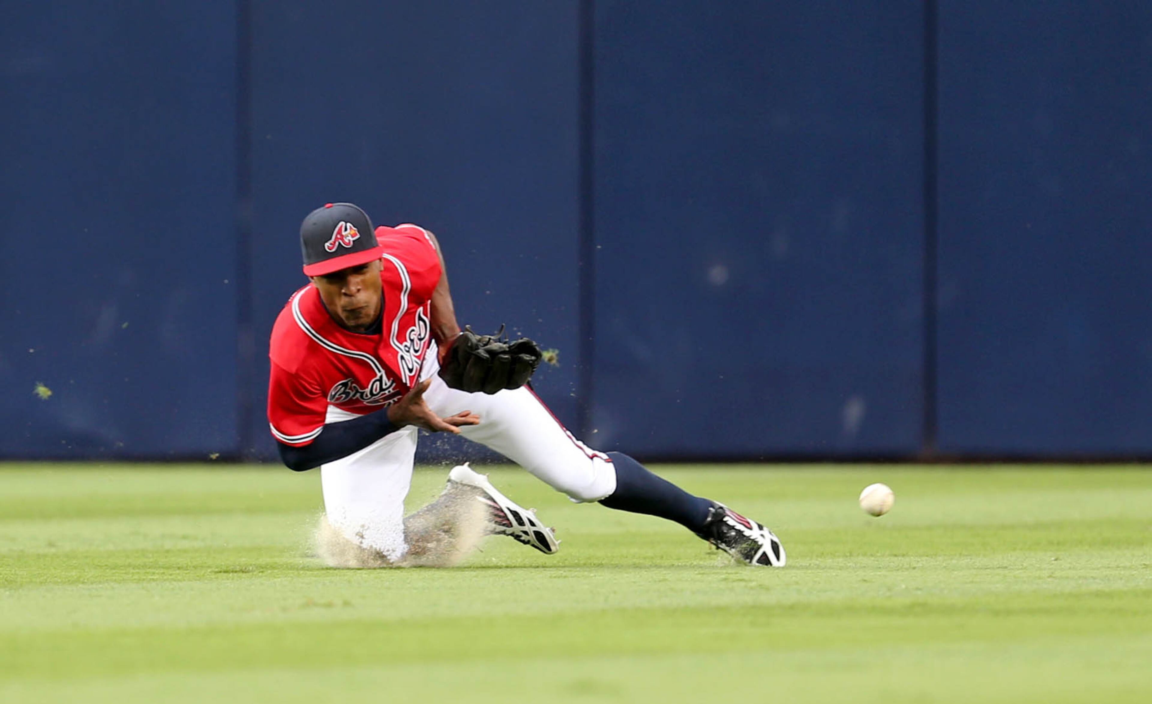 Braves center fielder B.J. Upton dives but is unable to make a catch on a triple by Cincinnati Reds Todd Frazier in the first inning of their game at Turner Field Friday night in Atlanta, Ga., July 12, 2013. Cincinnati's Joey Votto scored on the play. Upton was injured on the play and had to leave after the play. This is the second of a four game series versus the Cincinnati Reds. JASON GETZ / JGETZ@AJC.COM