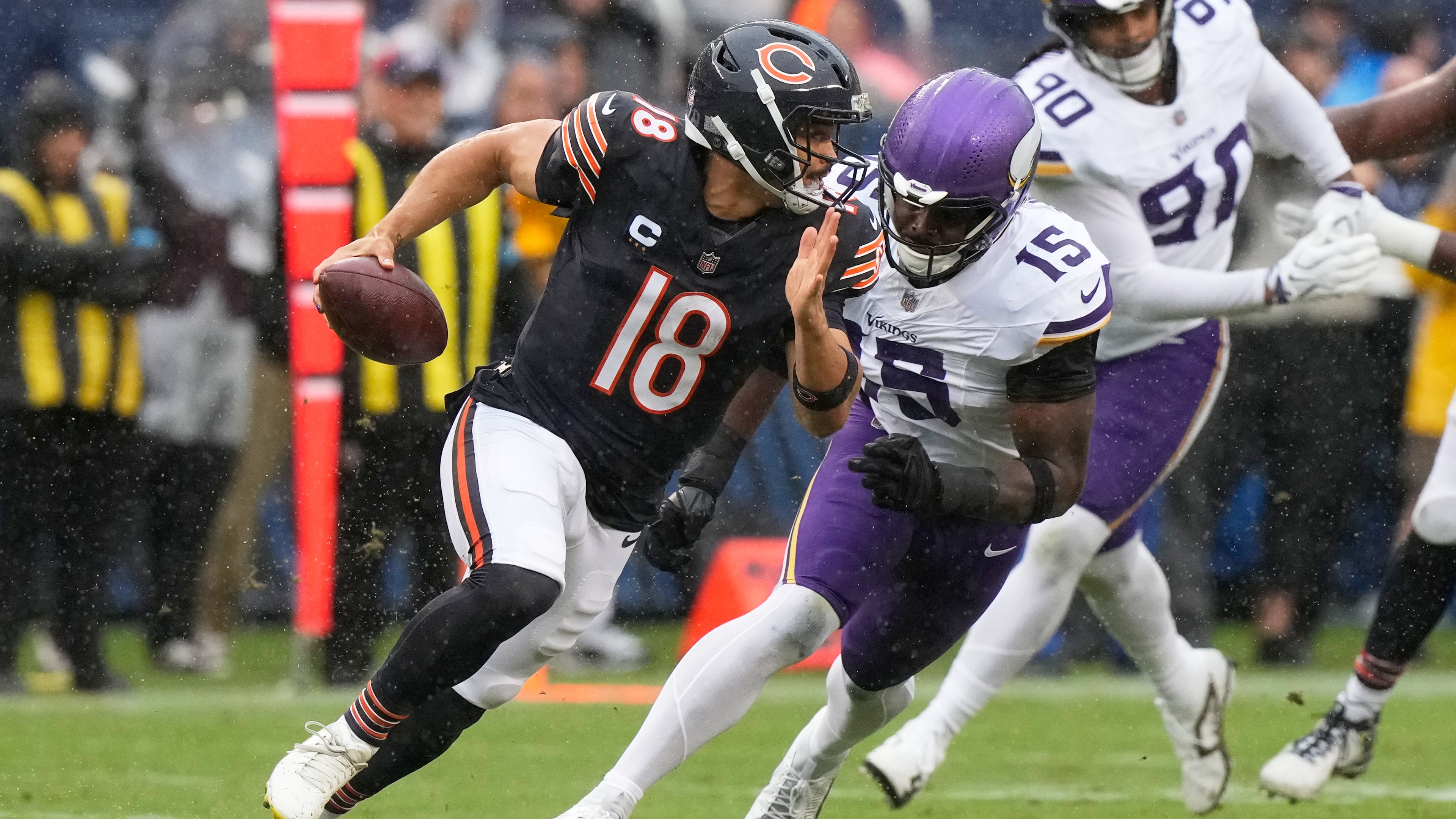 Chicago Bears quarterback Caleb Williams (18) scrambles as Minnesota Vikings outside linebacker Dallas Turner (15) defends during the first half of an NFL football game in Chicago, Sunday, Sept. 20, 2026. (AP Photo/Nam Y. Huh)