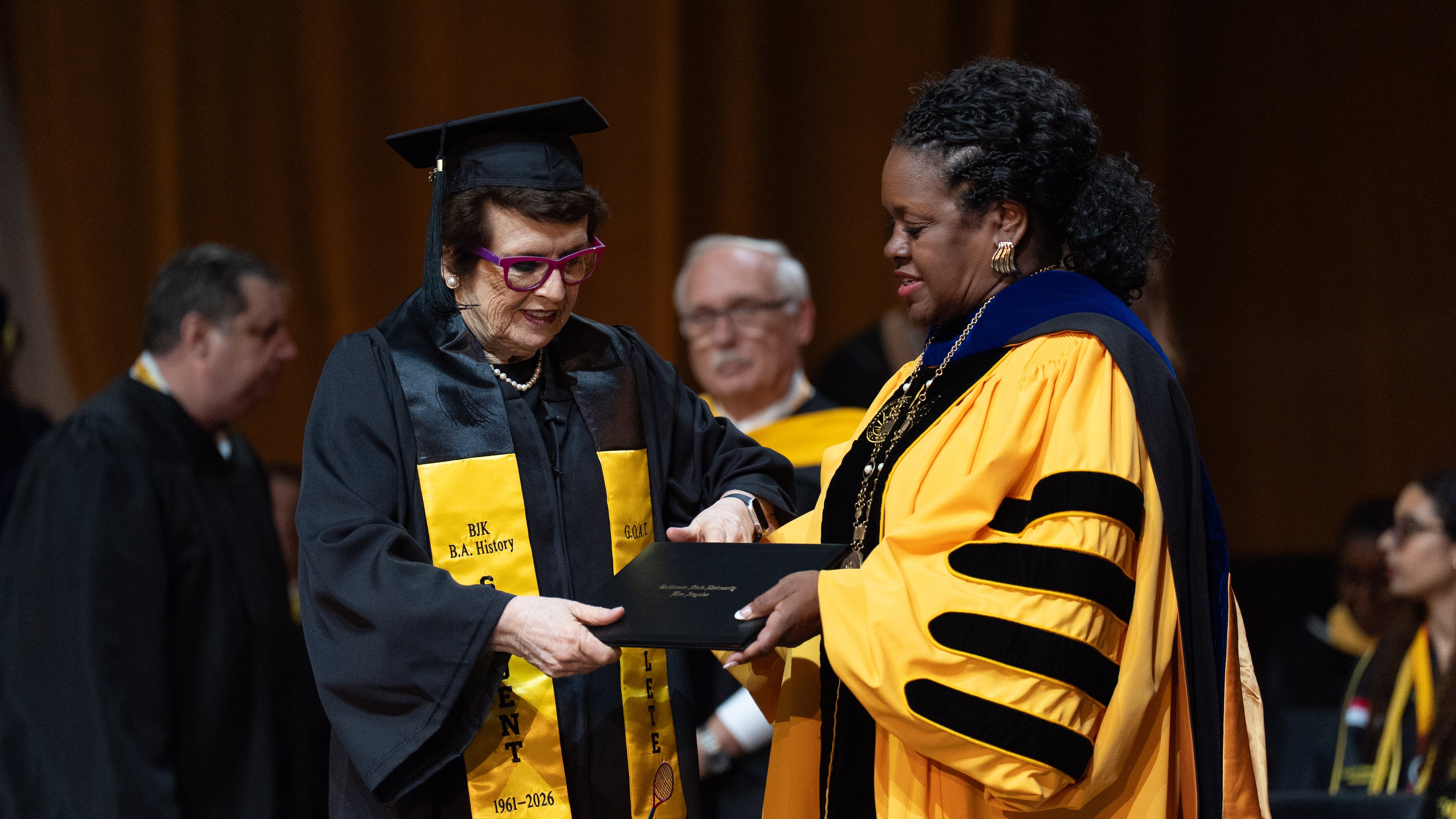 Tennis legend Billie Jean King, left, receives her diploma from California State University, Los Angeles, President Berenecea Johnson Eanes during commencement in Los Angeles, Monday, May 18, 2026. (AP Photo/Jae C. Hong)