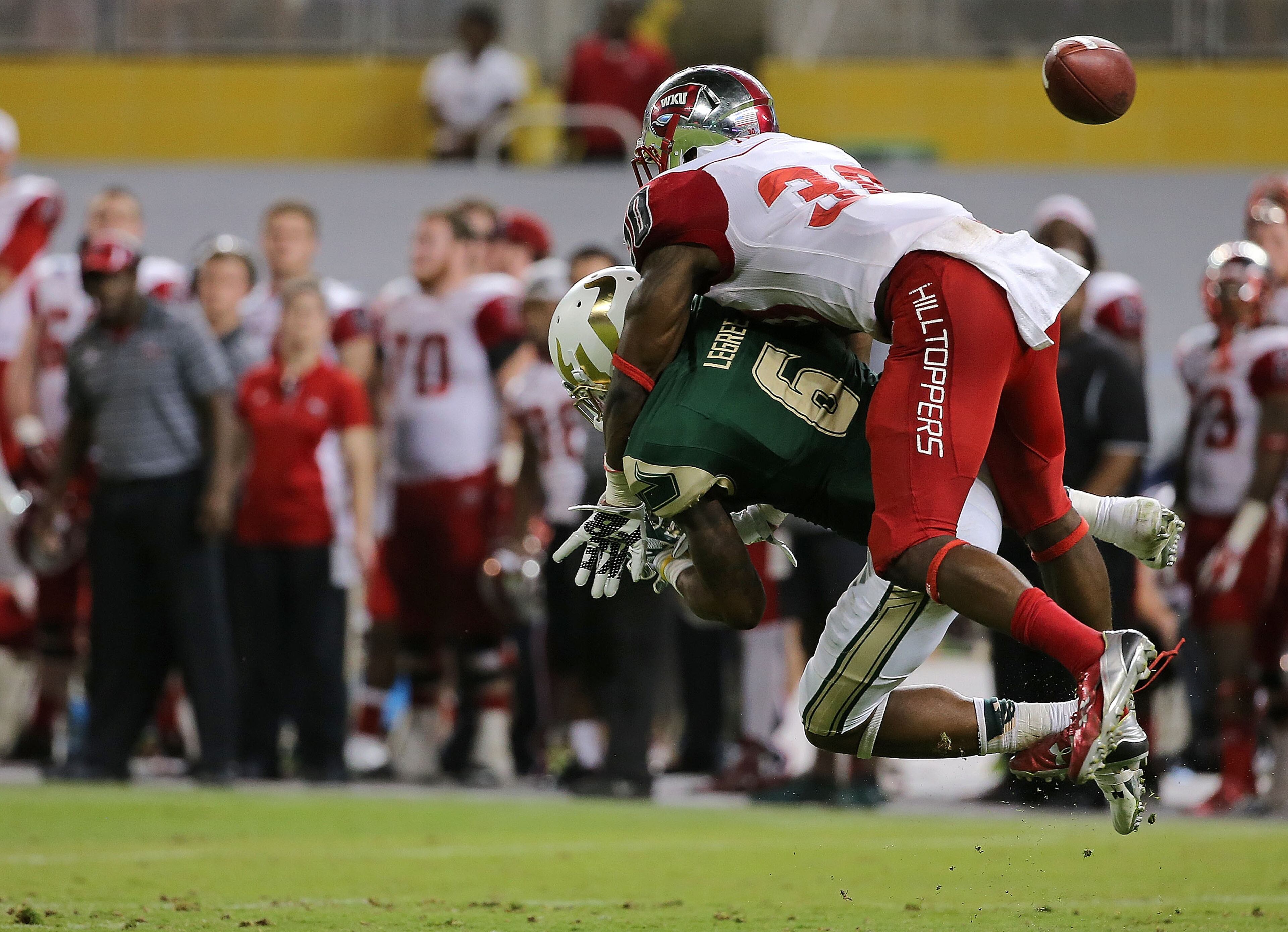 MIAMI, FL - DECEMBER 21: A.J. Legree #6 of the South Florida Bulls has a pass blocked by Prince Charles Iworah #30 of the Western Kentucky Hilltoppers during the 2015 Miami Beach Bowl at Marlins Park on December 21, 2015 in Miami, Florida. (Photo by Mike Ehrmann/Getty Images)