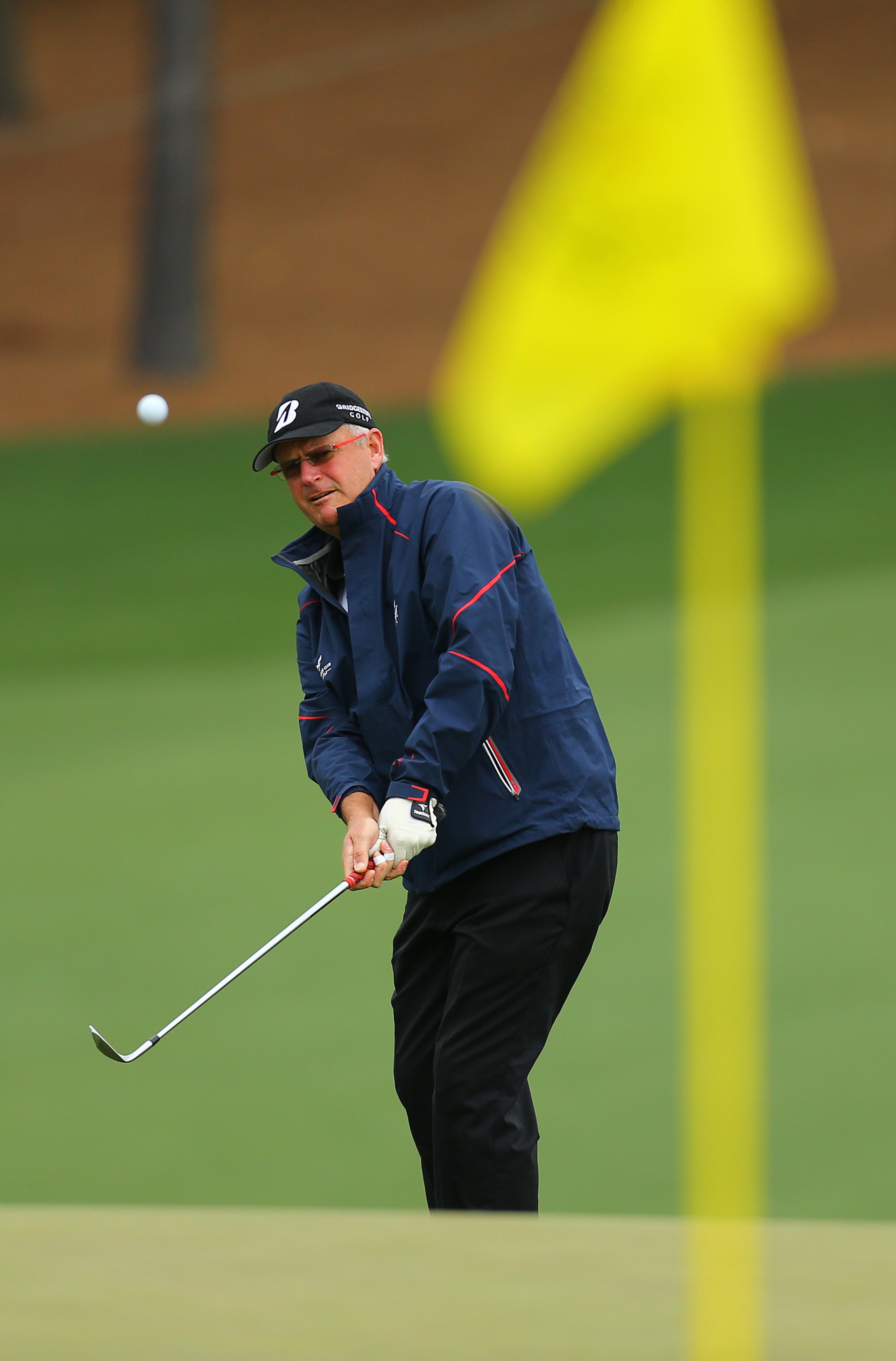 The 1988 Masters champion Sandy Lyle chips to the 9th green during his practice round at Augusta National Golf Club on Sunday, April 6, 2014, in Augusta. CURTIS COMPTON / CCOMPTON@AJC.COM