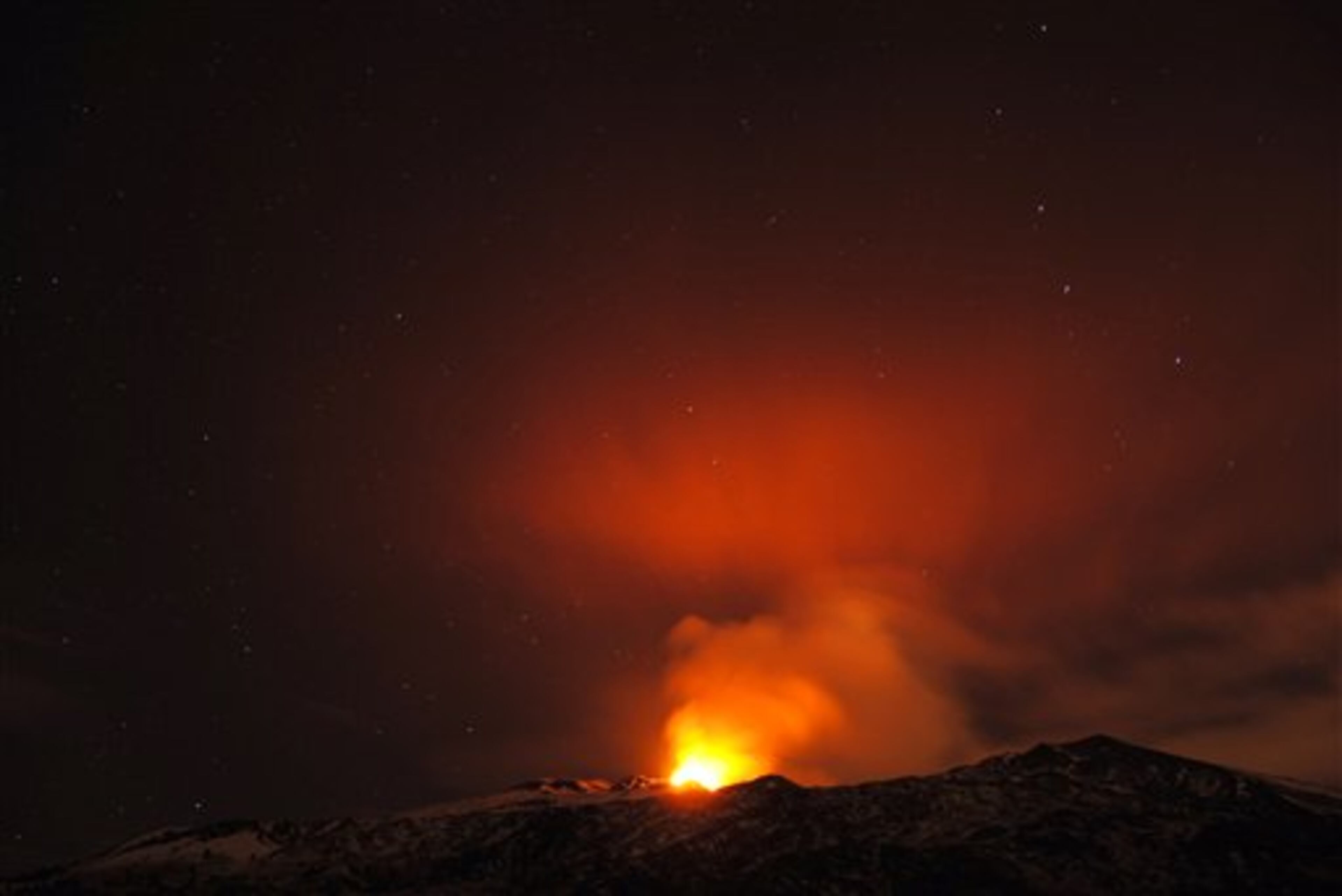 Mt. Etna's South East Crater erupts during a starry night, in Sicily, southern Italy, early Monday, Dec. 30, 2013. Mt. Etna, Europe's most active volcano at 3,350 meters (10,990 feet) erupts quite frequently, the last eruption occurred a couple of weeks ago, causing no damages. (AP Photo/Salvatore Allegra)