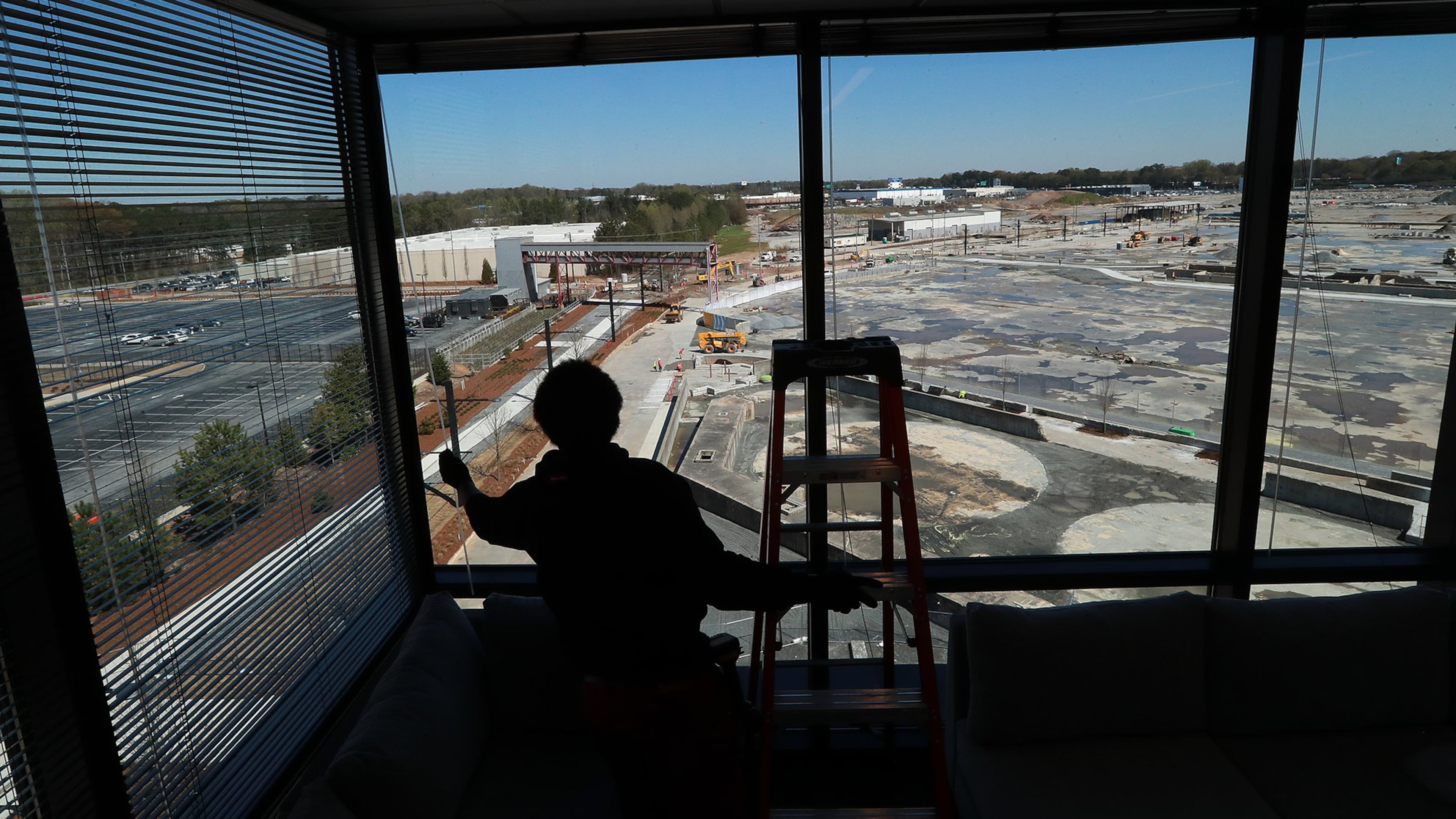 Orien Reid installs window blinds at the new Serta Simons Bedding headquarters overlooking the Assembly development in Doraville.