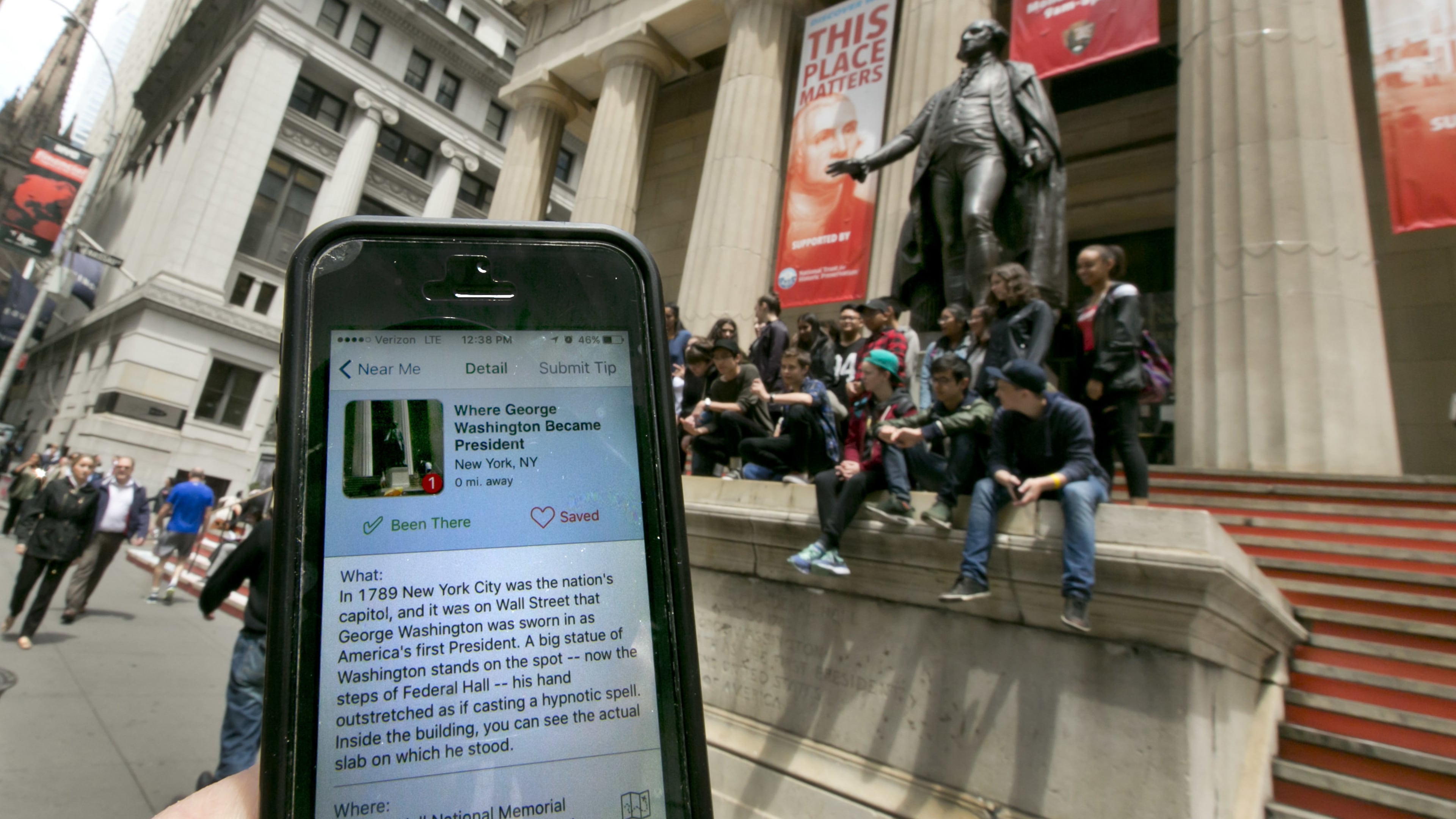 In this Tuesday, May 24, 2016, photo, the Roadside Presidents smartphone app directs people to the statue of George Washington on the steps of the Federal Hall National Monument, in New York’s Financial District. Heading out for a holiday weekend road trip? There are a number of apps available to entertain and educate along the way. (AP Photo/Richard Drew)