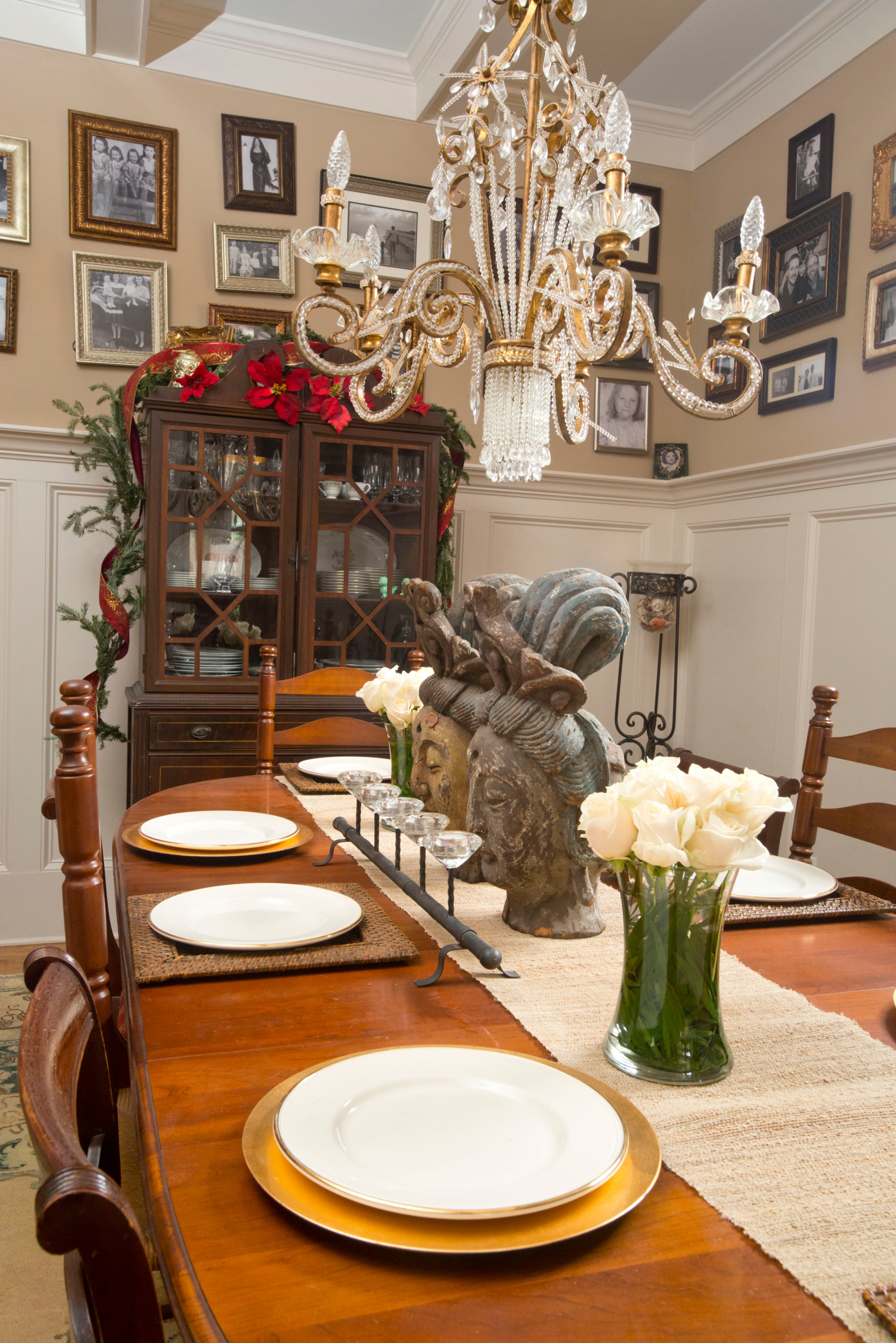 A friend from England gave them the dining table, which they paired with chairs passed down from James’ mother. Black-and-white photos of family were hung all over the dining room walls above the wainscoting. “That’s one of the major things that people fall in love with every time they come in,” Kevin said. One older photo is of James’ mother before she went to an opera, and the mirror in that photo is hanging in the dining room, too.