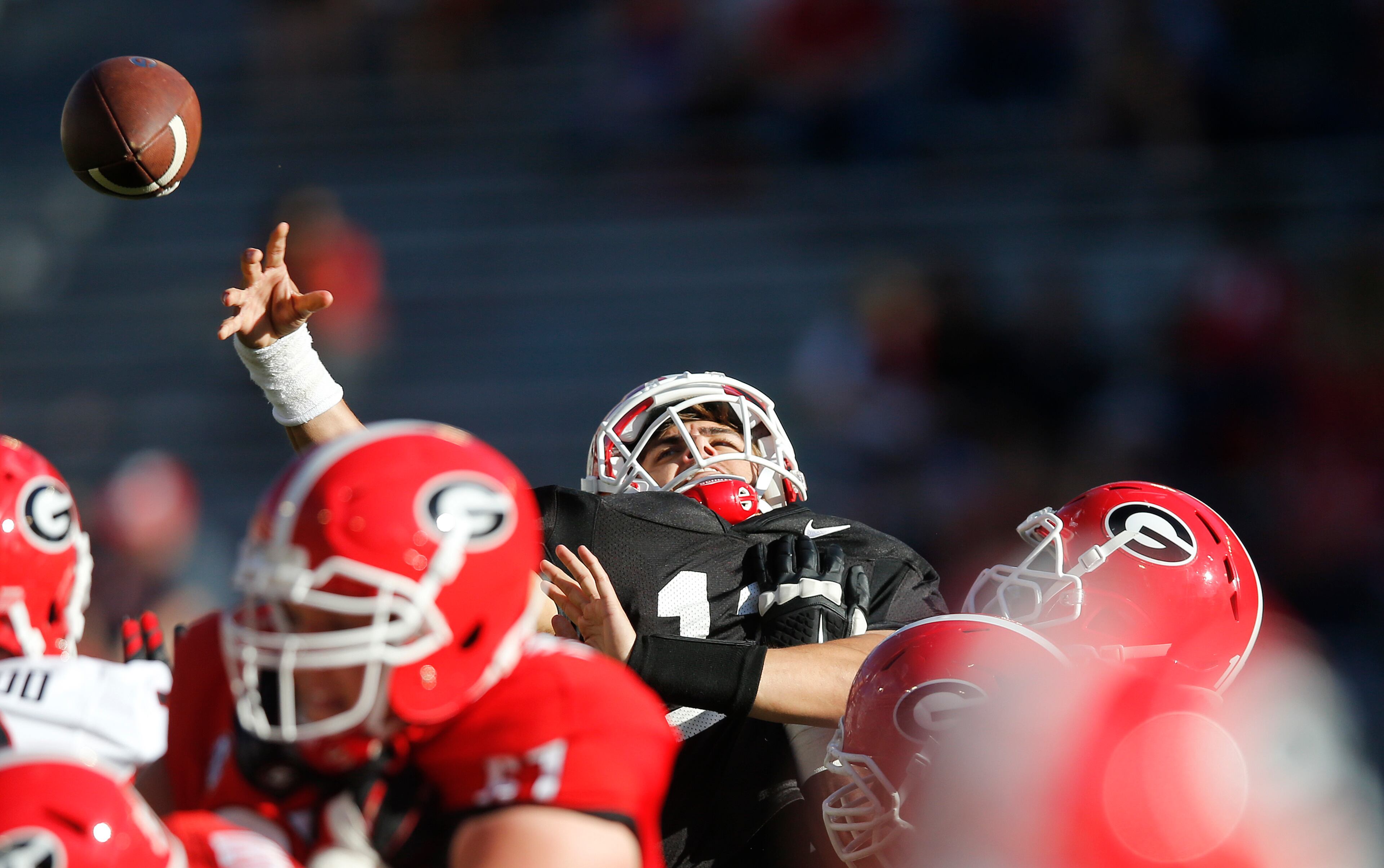 Georgia quarterback Greyson Lambert (11) is hit as he releases a pass during the second half of the NCAA college football team's spring game Saturday, April 16, 2016, in Athens, Ga. (AP Photo/John Bazemore)