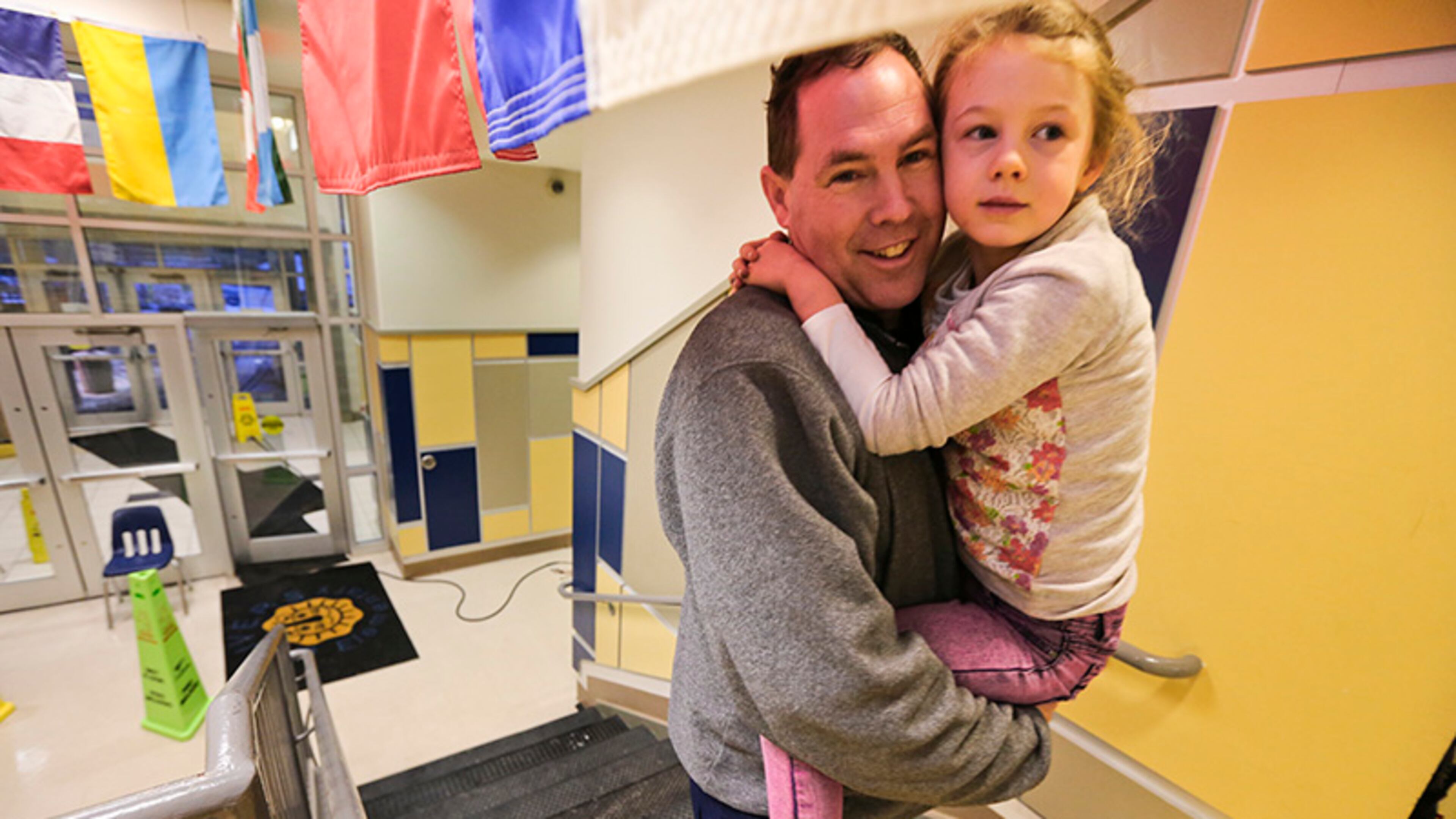Mark Nilson walked six miles from his home to spend the night with his 5-year-old daughter, Elizabeth, a kindergartner. at E. Rivers Elementary in Atlanta. More than 100 schoolchildren and 35 staff members including some parents and bus drivers spent the night at the school. Two movies with popcorn was served after a pizza dinner from the cafeteria. Some parents were able to come during the night and retrieve their children. Some even walked.