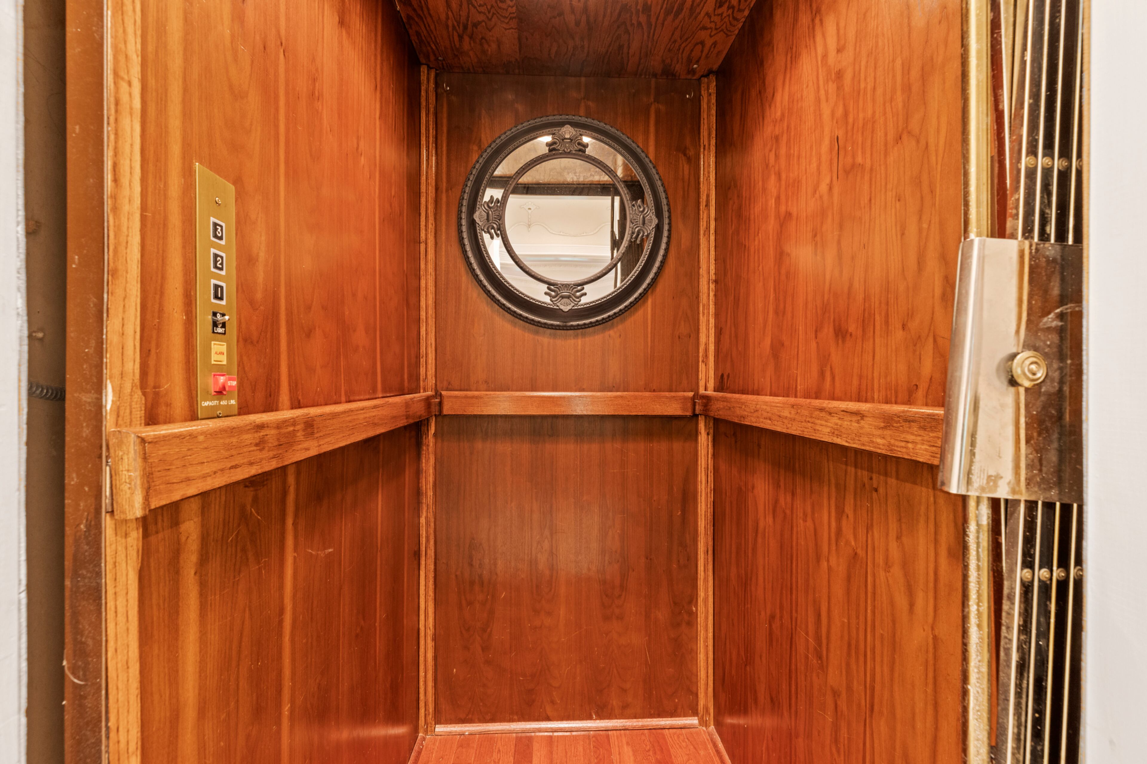 The private elevator has gorgeous wood paneling. Text by Ashley J. Webb