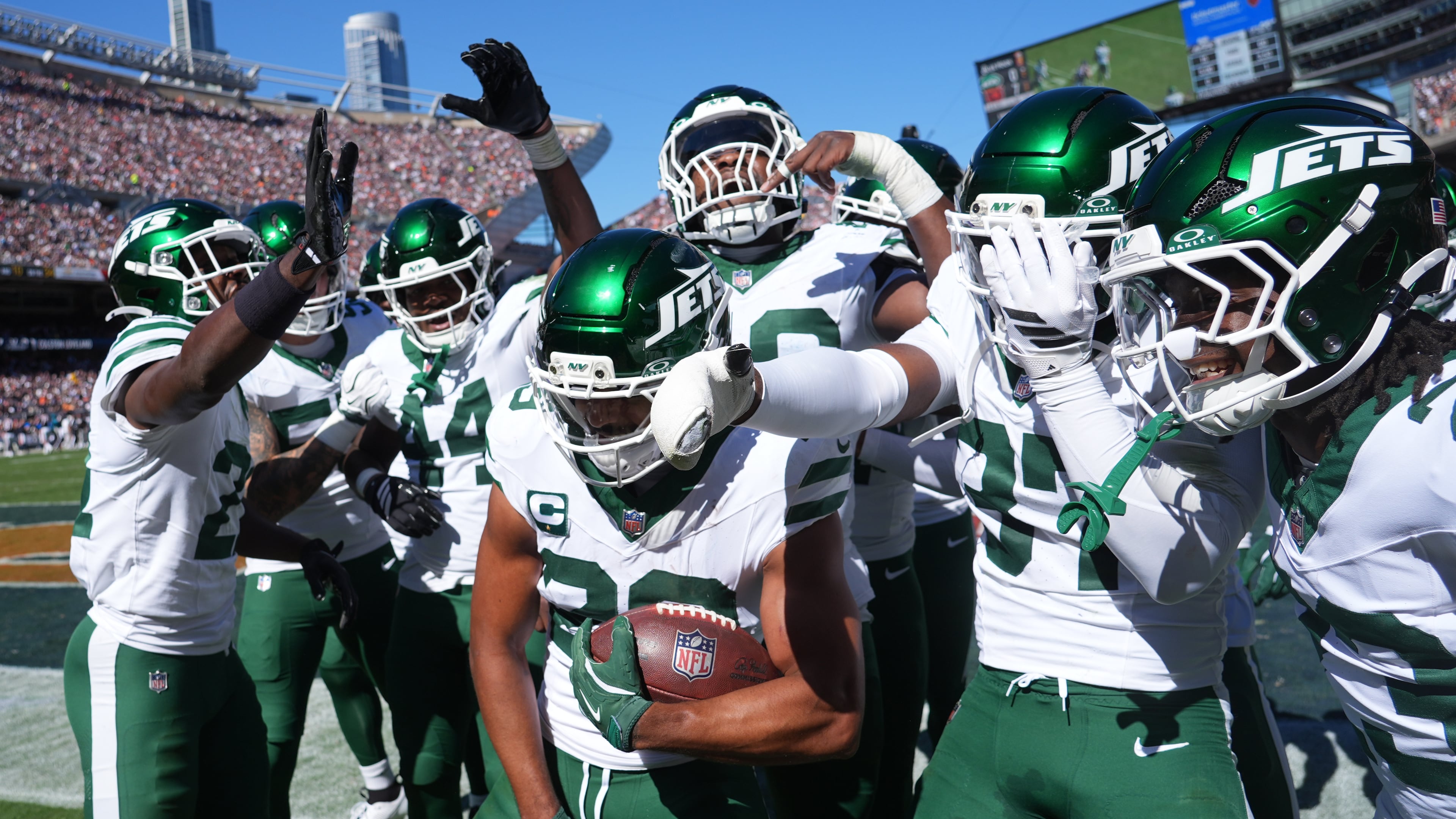 New York Jets safety Minkah Fitzpatrick holds the ball as he celebrates with teammates after intercepting a pass during the first half of an NFL football game against the Chicago Bears Sunday, Oct. 4, 2026, in Chicago. (AP Photo/David Banks)