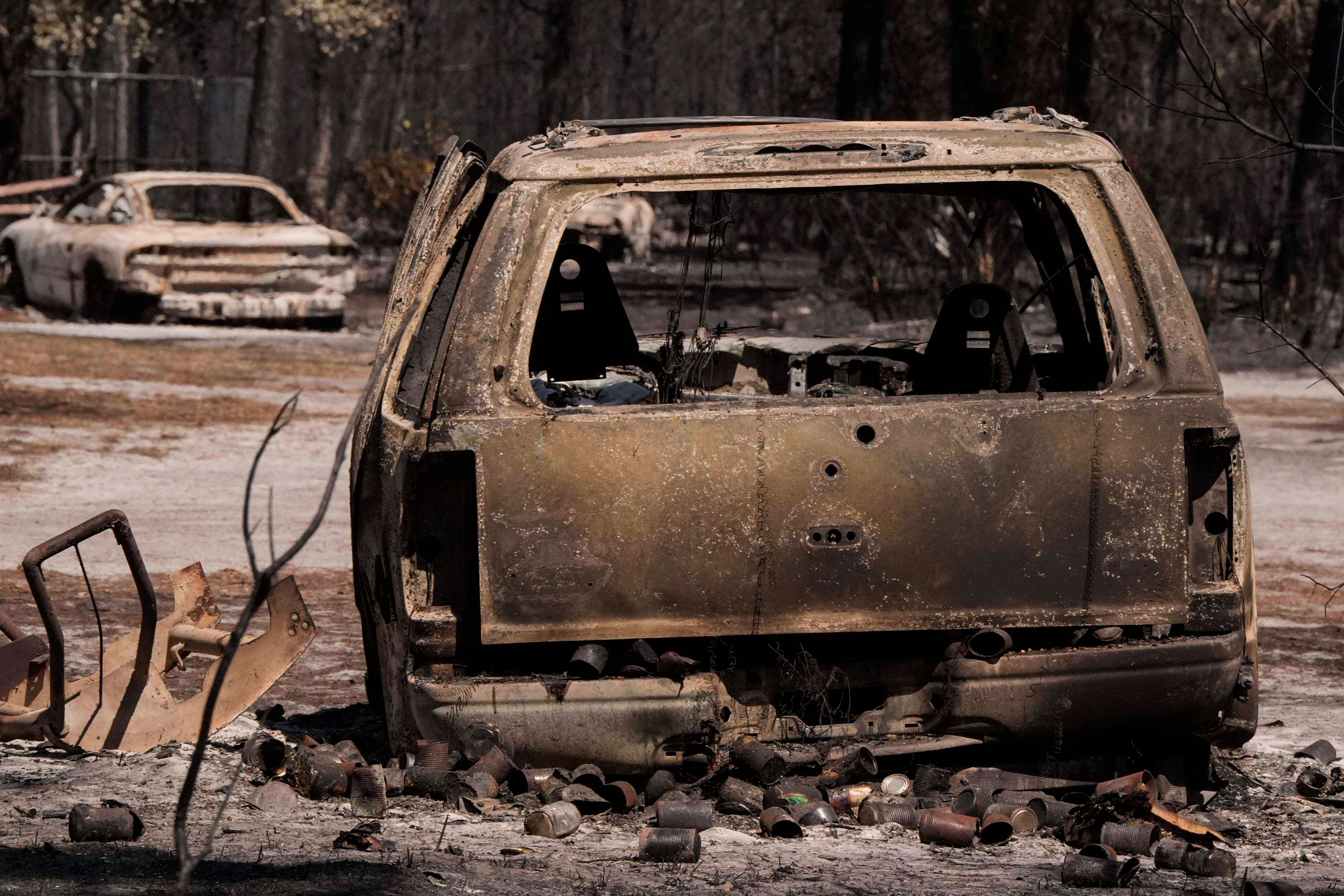 A burned vehicle sits near a destroyed home as the Brantley Highway 82 fire burns on Thursday, April 23, 2026, near Nahunta. (Mike Stewart/AP)