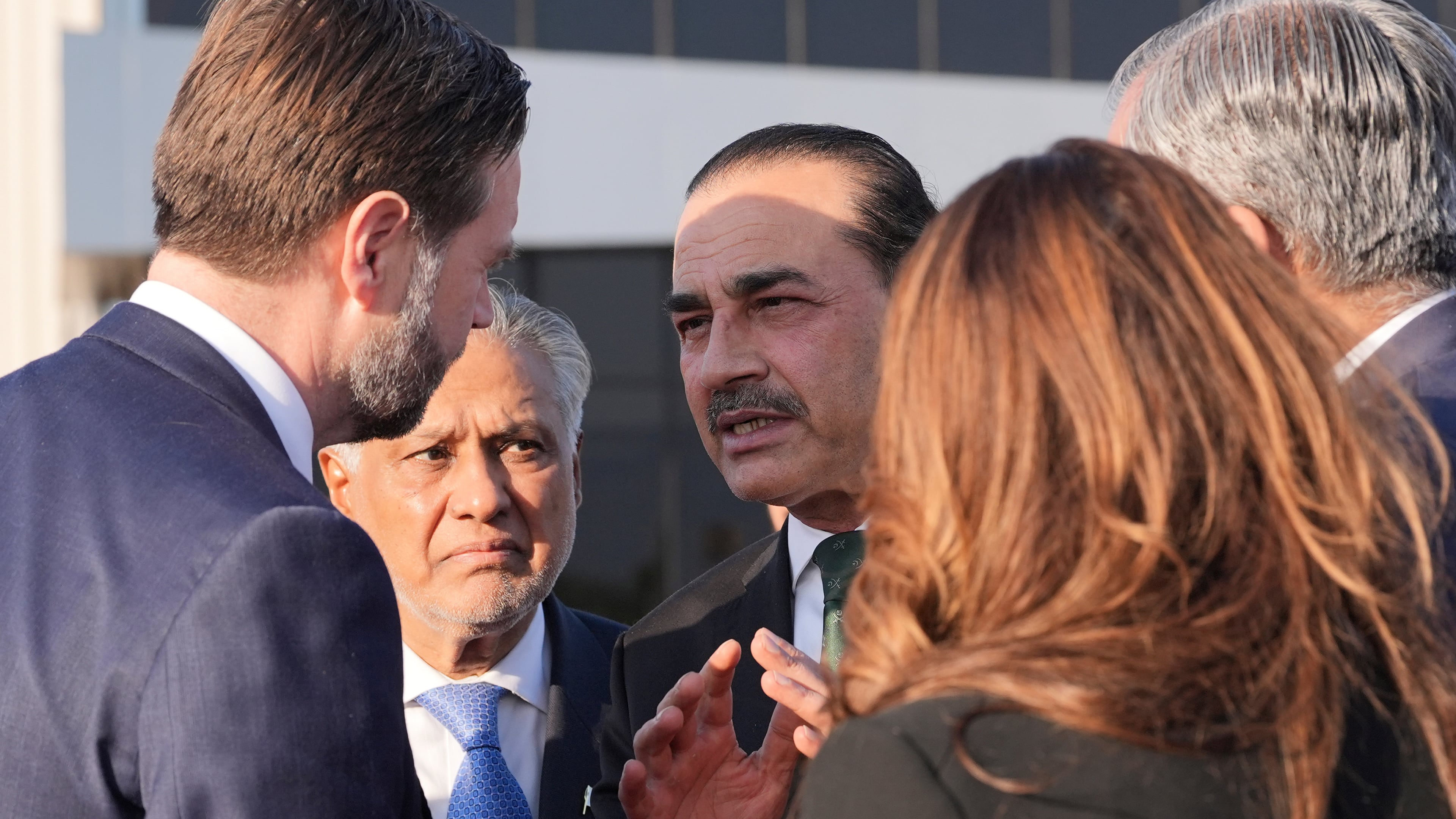 Vice President JD Vance, left, talks to Pakistan's Chief of Defence Forces and Chief of Army Staff Field Marshall Asim Munir, right, and Pakistani Deputy Prime Minister and Foreign Minister Mohammad Ishaq Dar, center, before boarding Air Force Two after attending talks on Iran in Islamabad, Pakistan, Sunday, April 12, 2026. (AP Photo/Jacquelyn Martin, Pool)