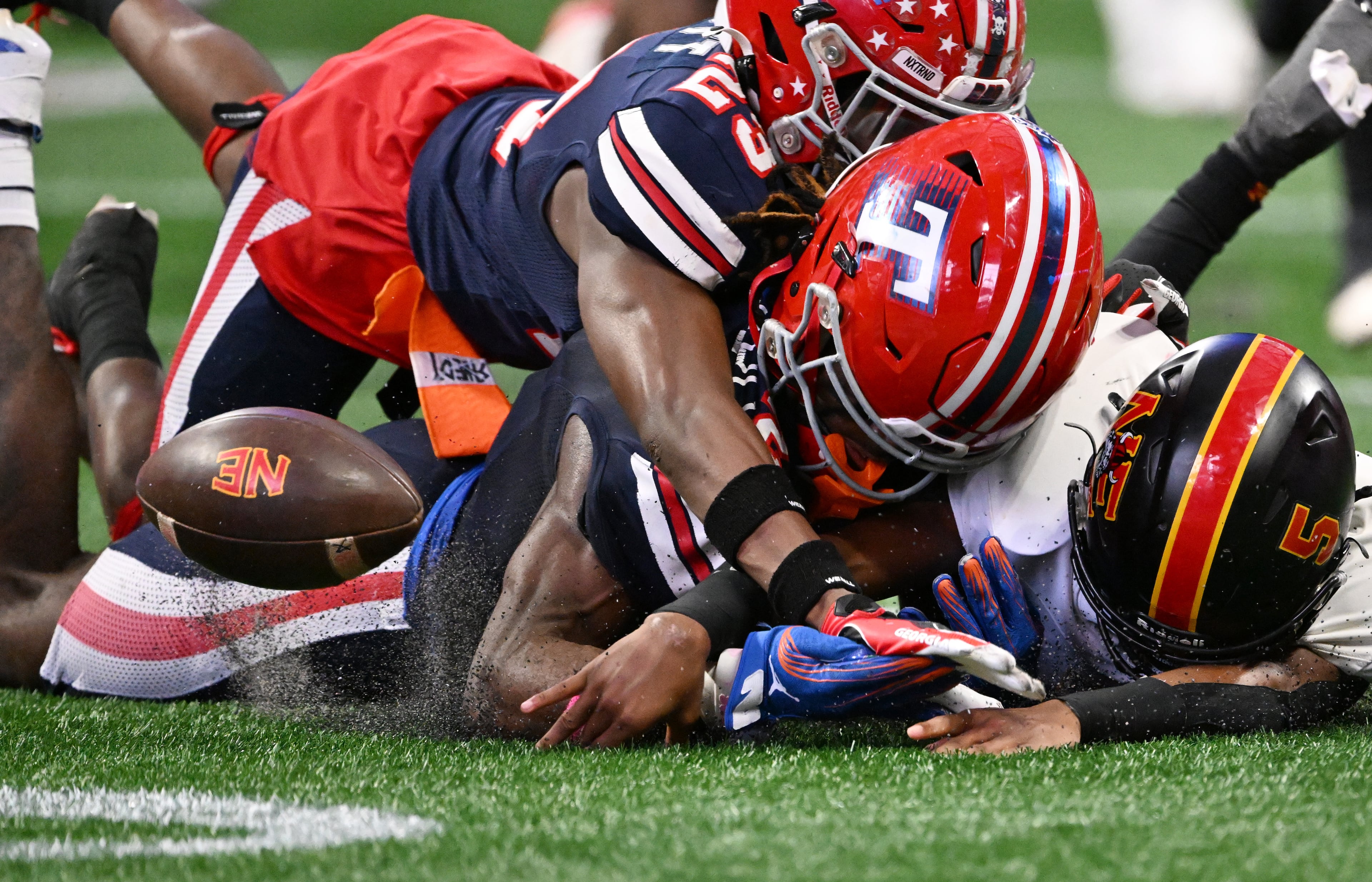 Toombs County's Alex Scott (left) Toombs County's Lagonza Hayward (center) and Northeast's Reginald Glover (5) fight to recover the fumble by Northeast's running back Nick Woodford during the first half in GHSA Class A-Division State Championship game at Mercedes-Benz Stadium, Tuesday, December 17, 2024, in Atlanta. (Hyosub Shin / AJC)
