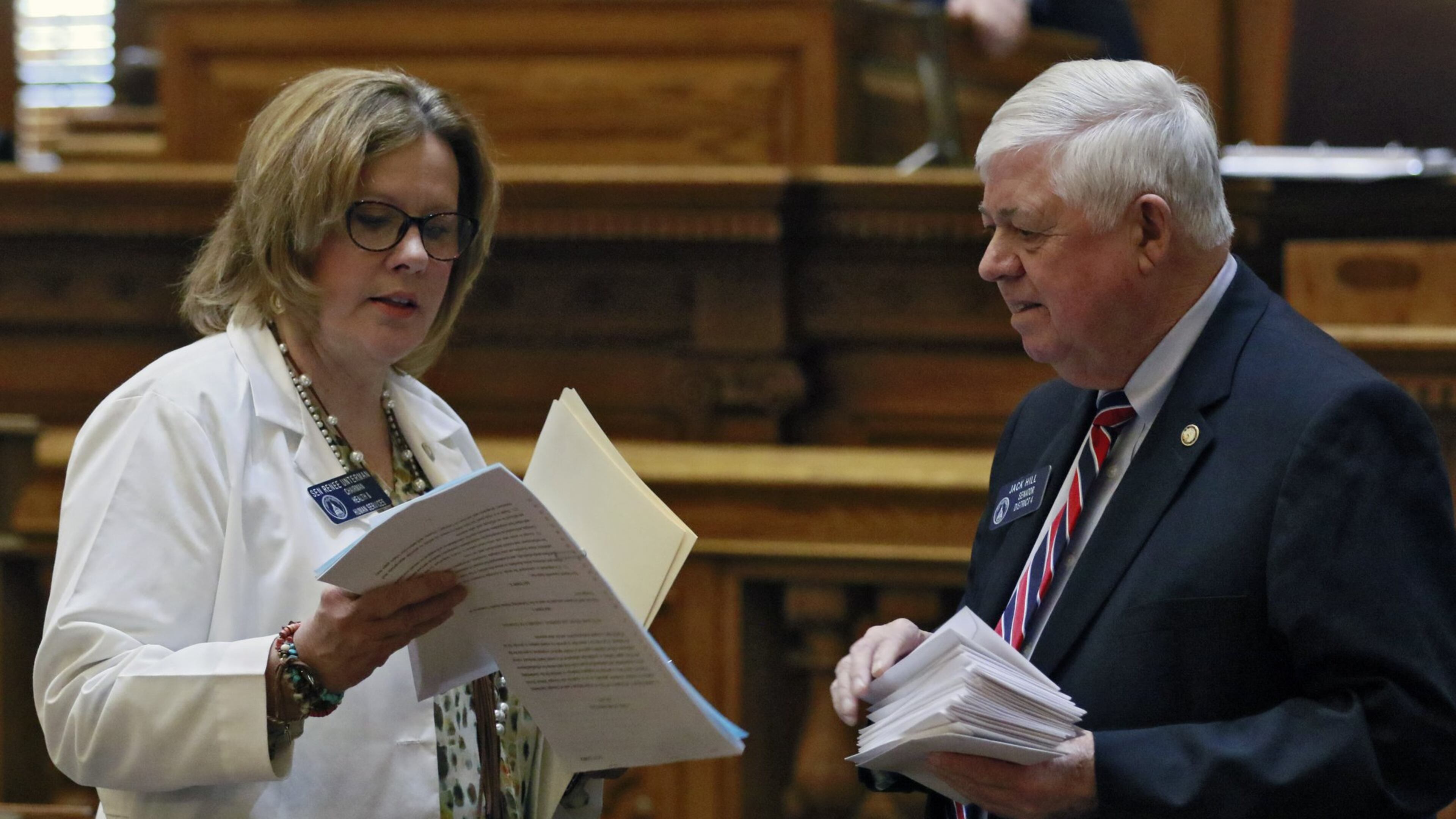 Georgia Sen. Renee Unterman, R-Buford, confers with Sen. Jack Hill on the floor of the Senate. BOB ANDRES /BANDRES@AJC.COM