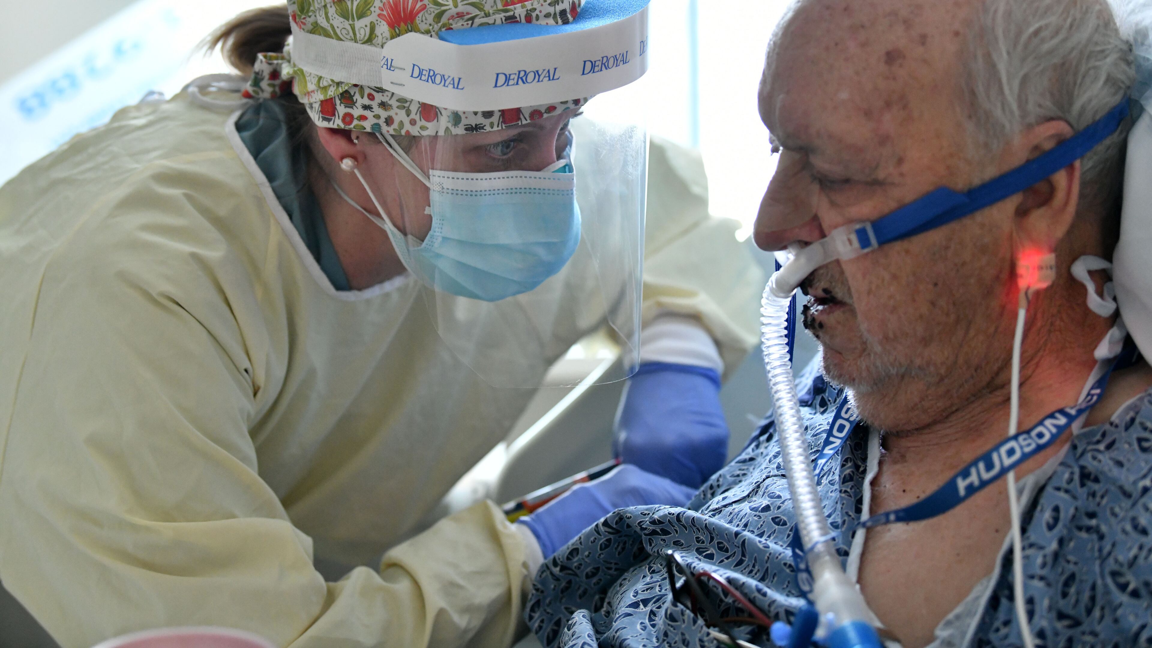 Nurse Allison Jacobs checks on Jack Bennett, who is infected with COVID-19 in the temporary COVID-19 ICU at Northeast Georgia Medical Center (NGMC) in Gainesville on Wednesday. For doctors working in hospitals, the last two weeks have been the most deadly in the COVID-19 battle. (Hyosub Shin / Hyosub.Shin@ajc.com)