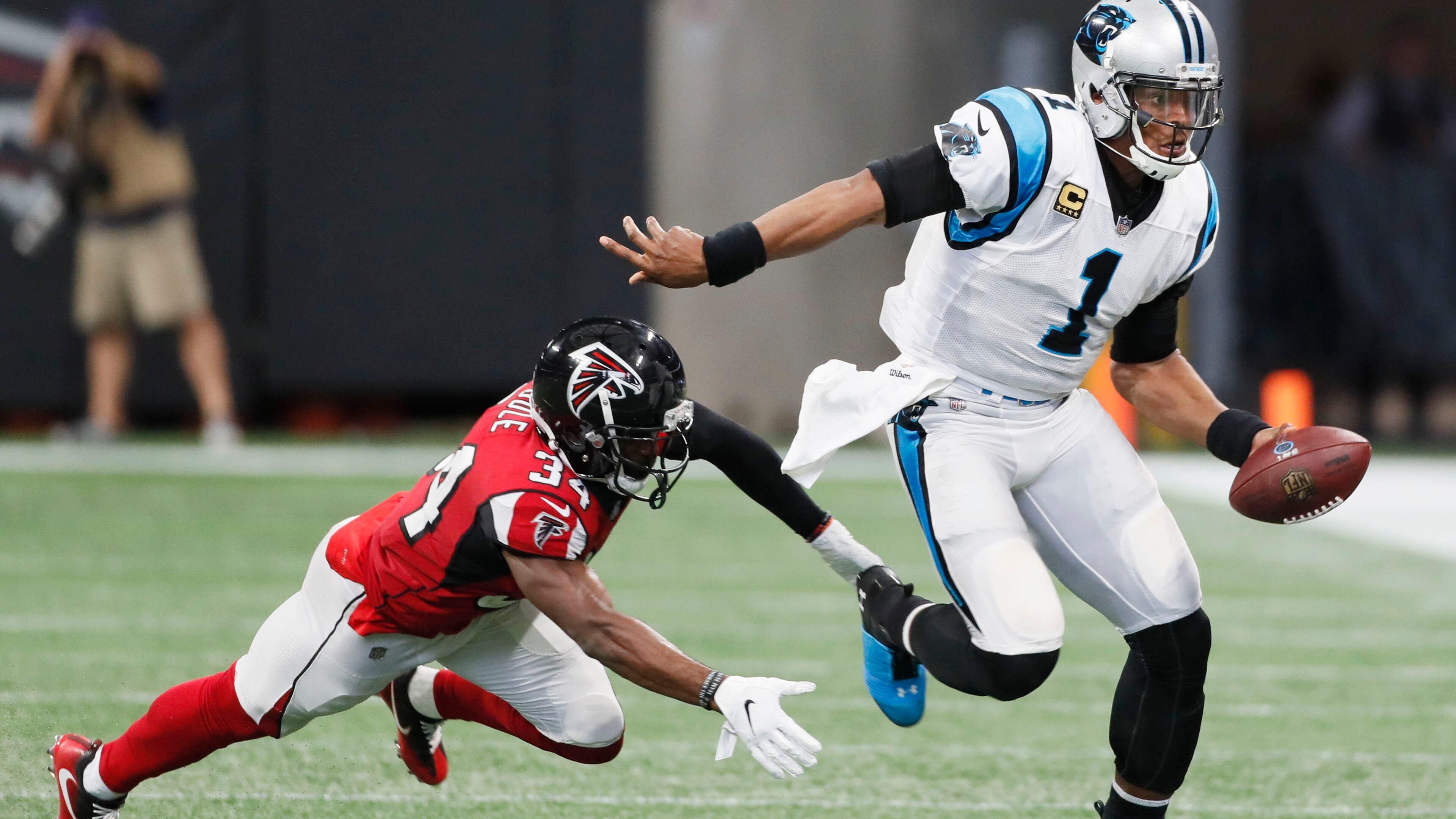 Carolina Panthers quarterback Cam Newton (1) evades Atlanta Falcons cornerback Brian Poole in 2018.