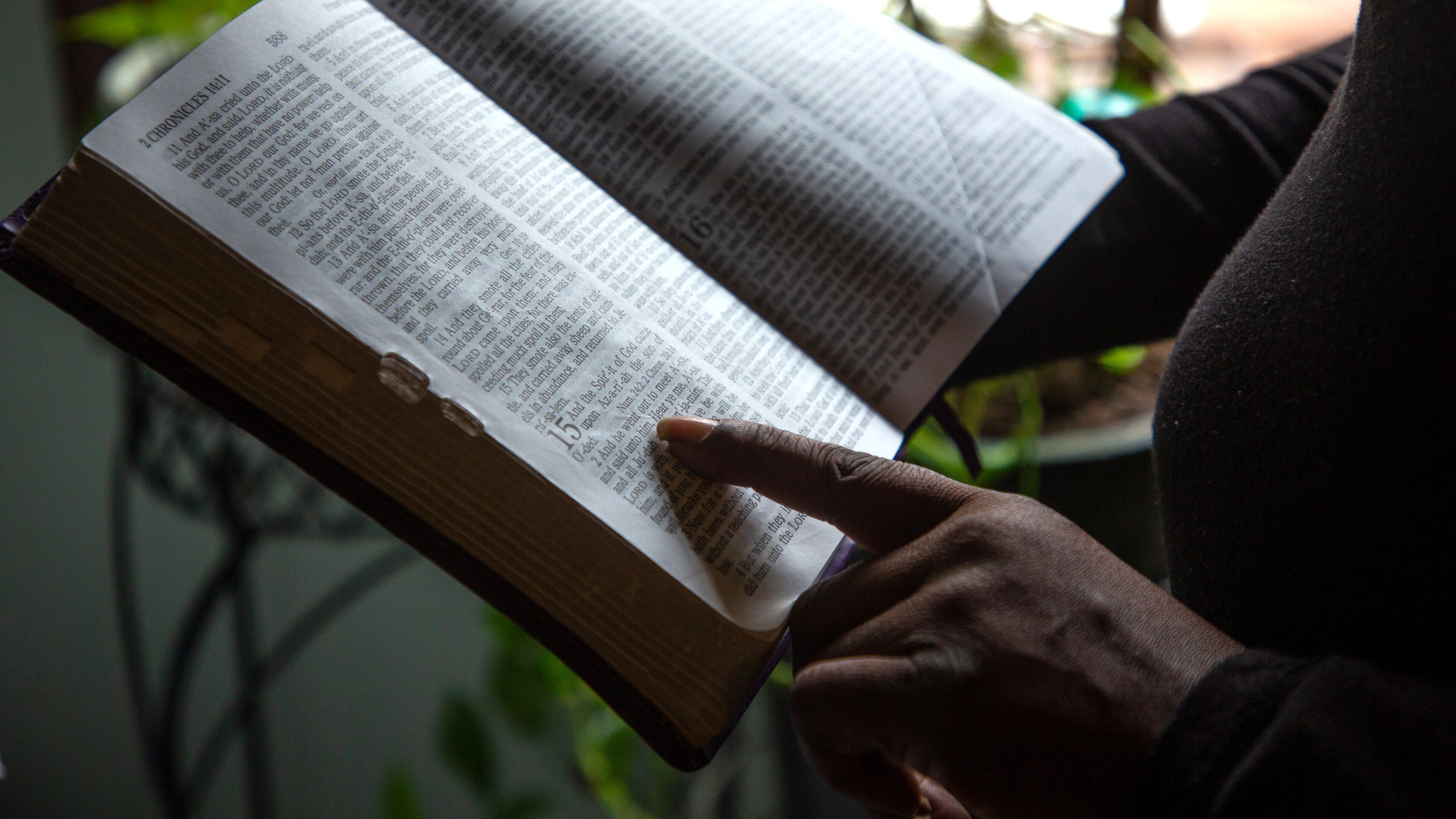 A client of the federal Housing Opportunities for Persons with AIDS program reads her mother's bible at the Ellenwood house where she was staying Sunday, December 23, 2021. She is homeless after her case fell through the cracks of the city of Atlanta-run program. STEVE SCHAEFER FOR THE ATLANTA JOURNAL-CONSTITUTIONSTEVE SCHAEFER FOR THE ATLANTA JOURNAL-CONSTITUTION
