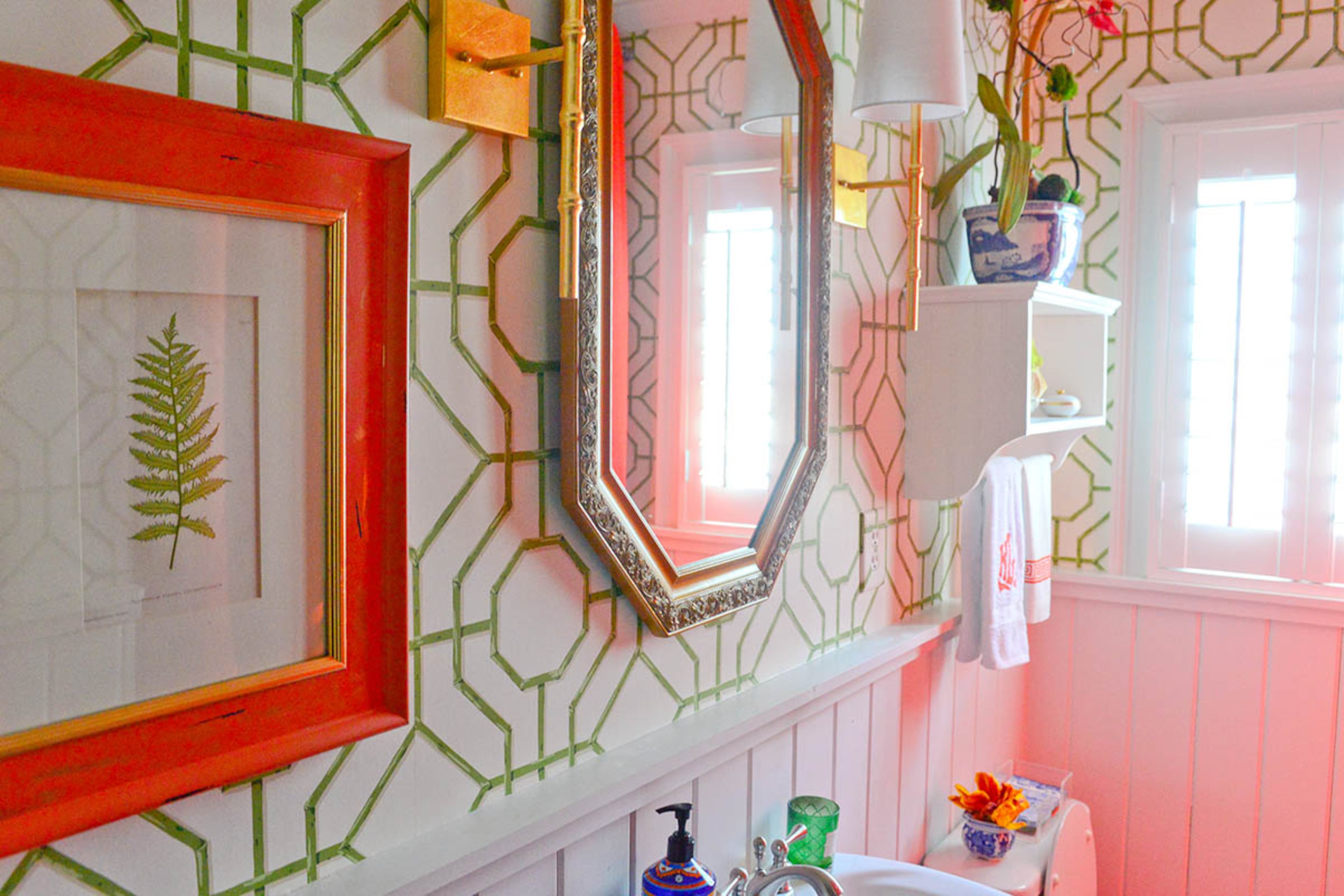 The white and vivid green bamboo wallpaper by Cowtan & Tout injects this year's "it" color - Pantone's Greenery - into the downstairs bathroom.