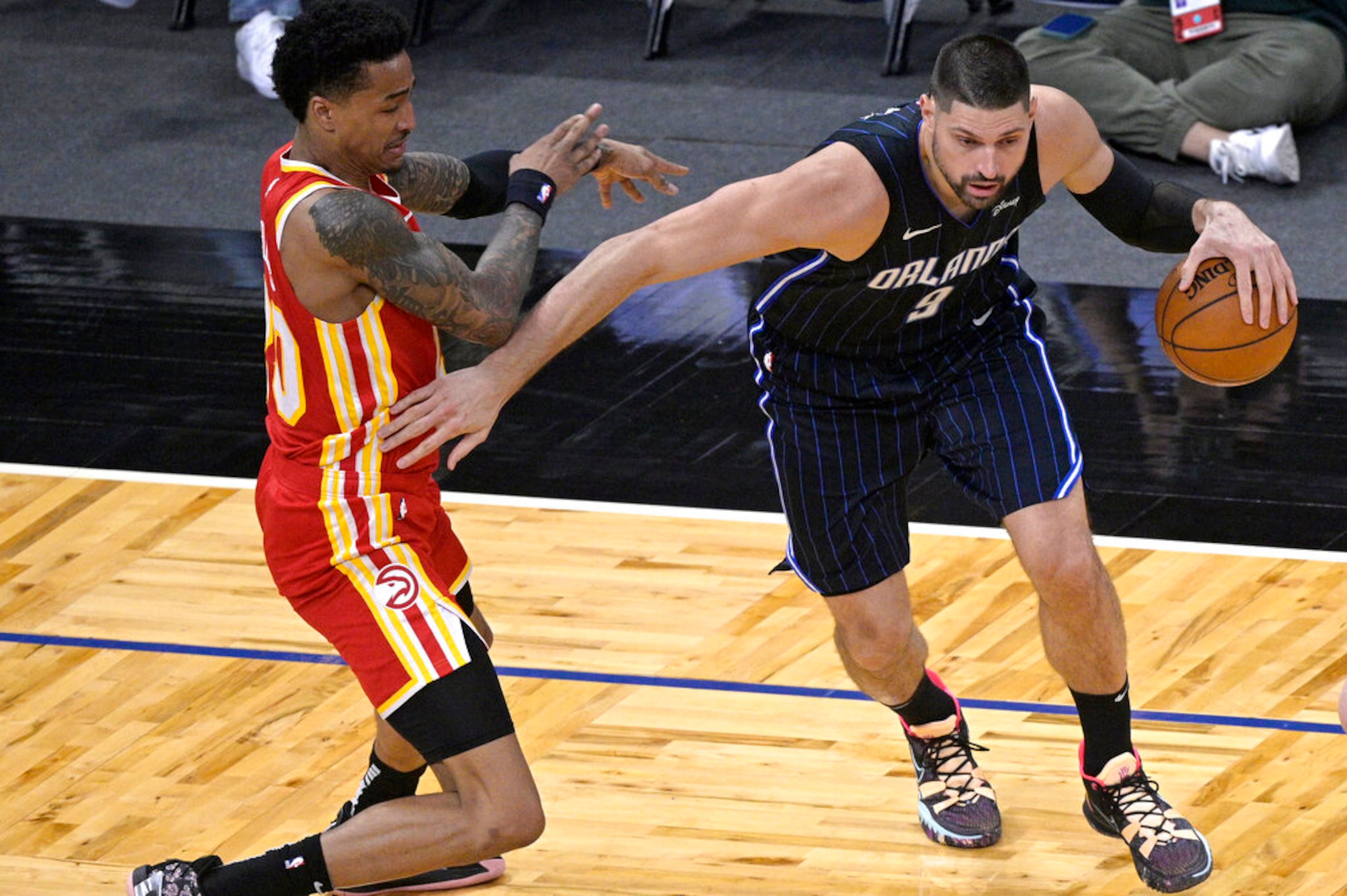 Orlando Magic center Nikola Vucevic (9) works around Atlanta Hawks forward John Collins during the first half of an NBA basketball game Wednesday, March 3, 2021, in Orlando, Fla. (AP Photo/Phelan M. Ebenhack)