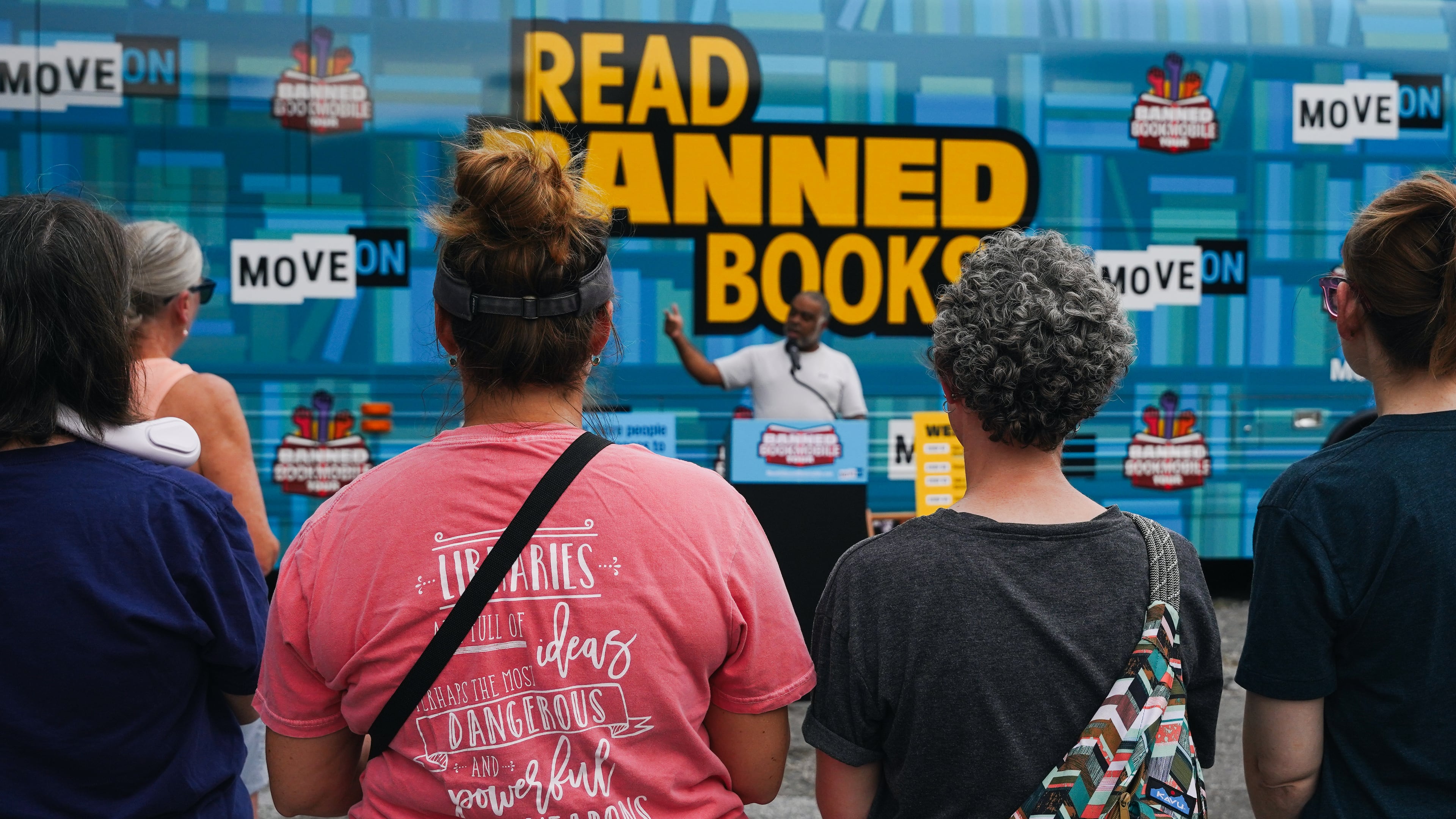 Erick Allen, former state representative and chair of Cobb County Democrats, speaks to visitors at the Marietta stop of the Banned Bookmobile Tour in 2023. (Olivia Bowdoin for the AJC)