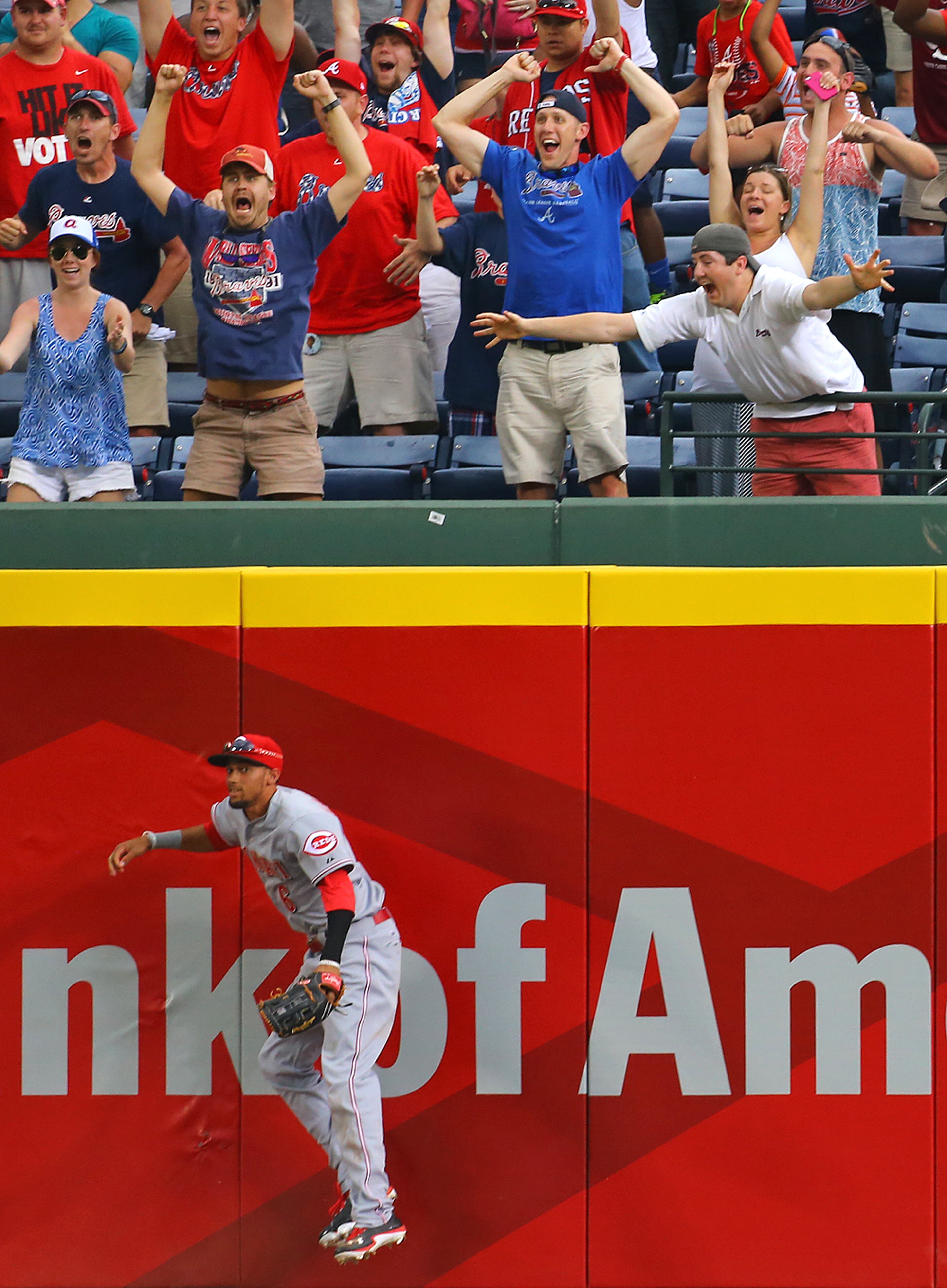 Braves fans react when Reds outfielder Billy Hamilton misses the game-winning RBI single by Freddie Freeman to beat the Reds 1-0 in the 10th inning of their MLB baseball game for the sweep on Sunday, April 27, 2014, in Atlanta. CURTIS COMPTON / CCOMPTON@AJC.COM