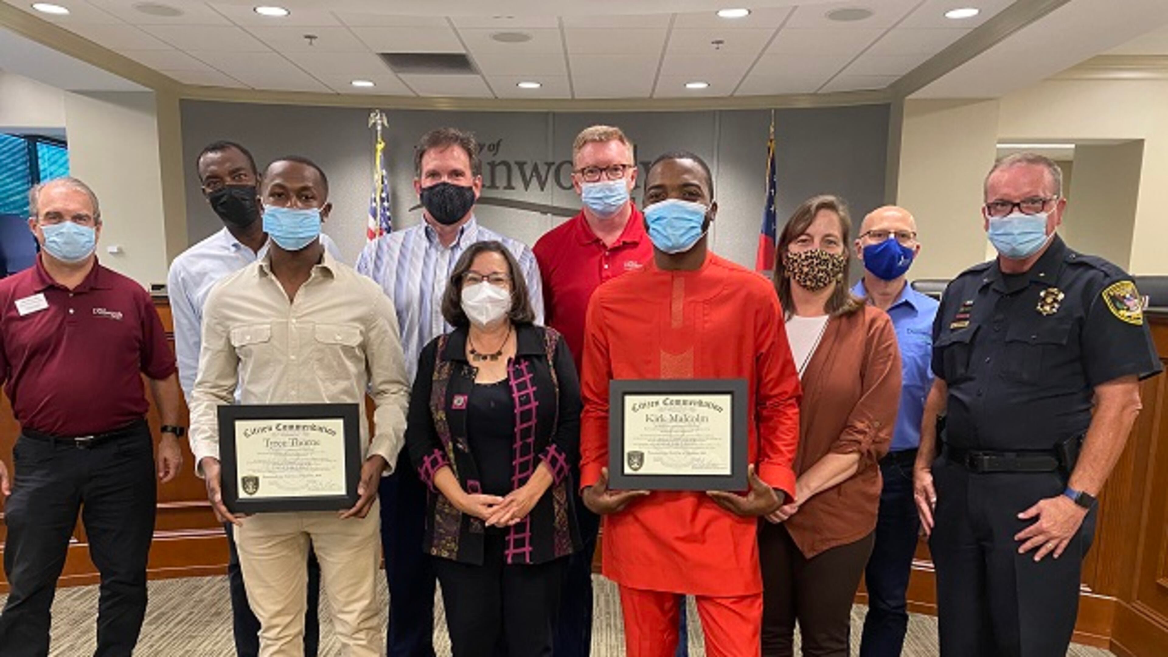 Holding their awards are (l-r) Tyree Thorne and Kirk Malcolm, with Dunwoody Mayor Lynn Deutsch standing between them. (Courtesy of Dunwoody)