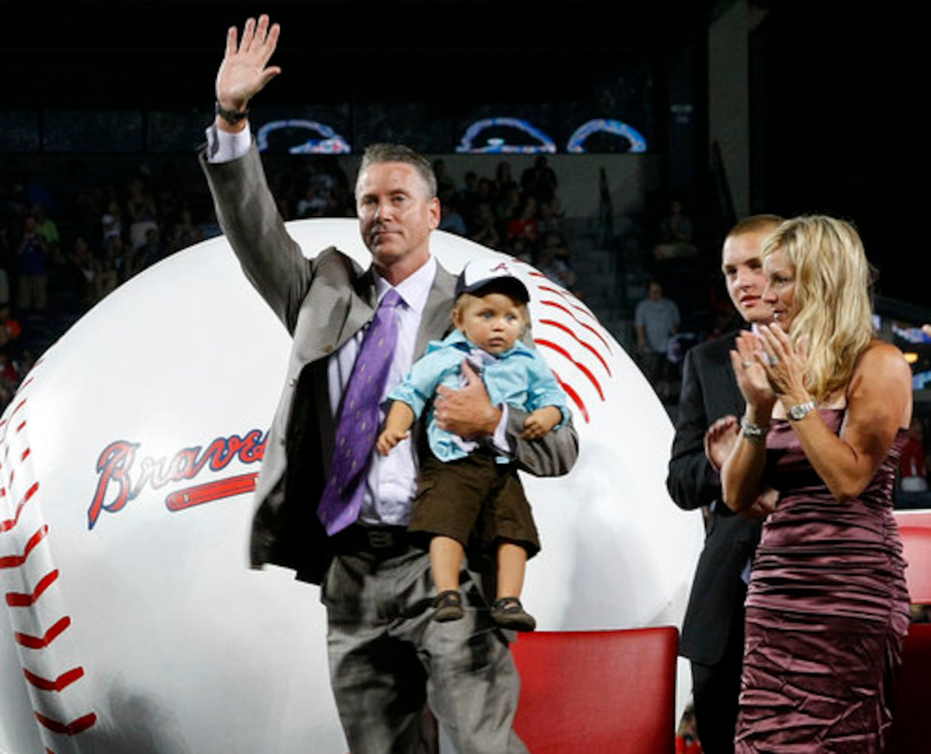 Tom Glavine holds his son Kienan, 1, as his wife Chris looks on during his uniform number retirement in a pre-game ceremony at Turner Field in Atlanta, Friday, August 6, 2010, before the game vs. the San Francisco Giants. Glavine's # 47 is the seventh Braves uniform number to be retired, joining Hank Aaron (44), Eddie Mathews (41), Dale Murphy (3), Phil Niekro (35), Warren Spahn (21), and Greg Maddux (31).