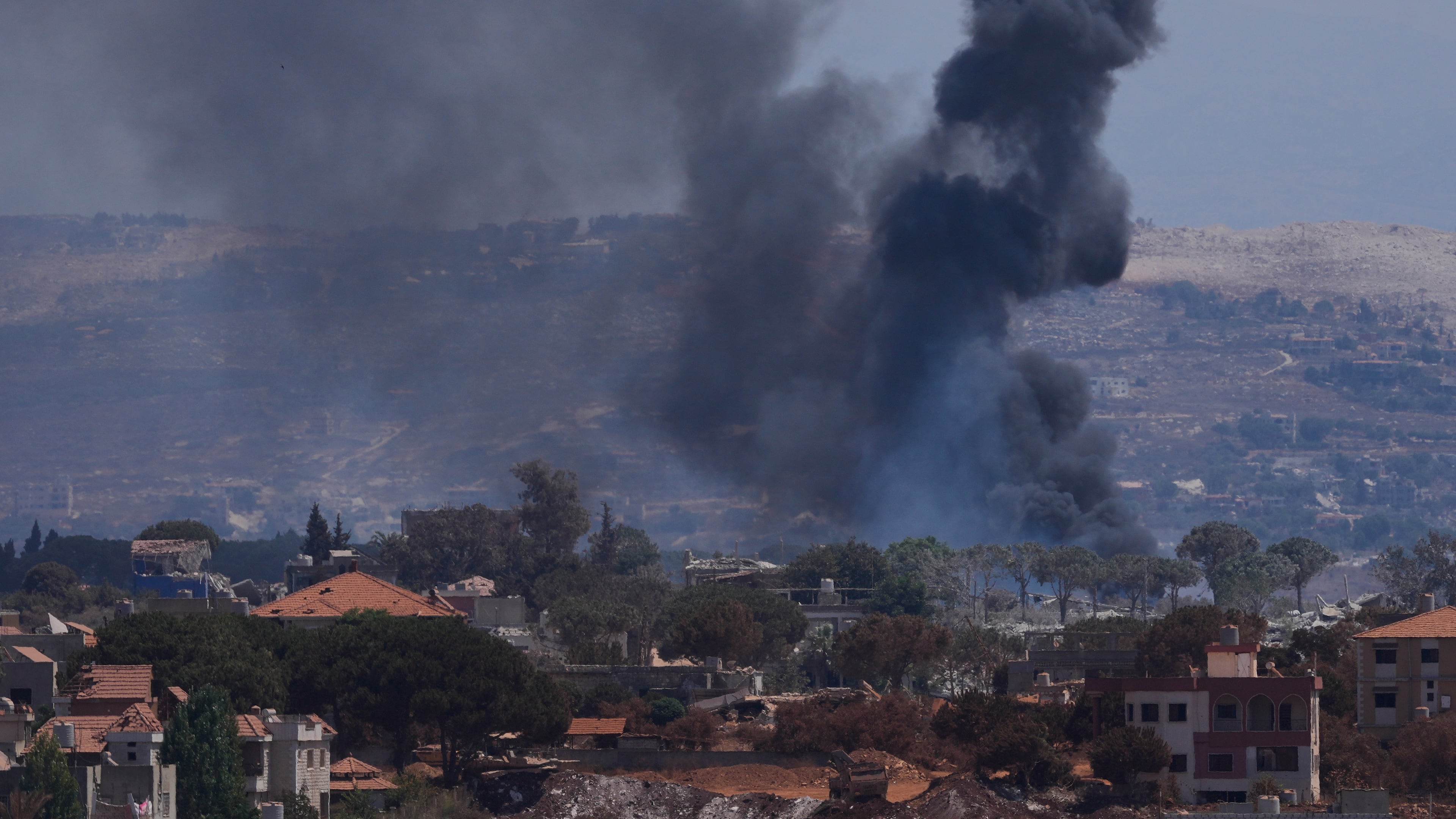 Smoke rises as Israeli forces demolish homes in Zawtar al-Sharqiyah, southern Lebanon, Sunday, Aug. 23, 2026. (AP Photo/Mohammed Zaatari)