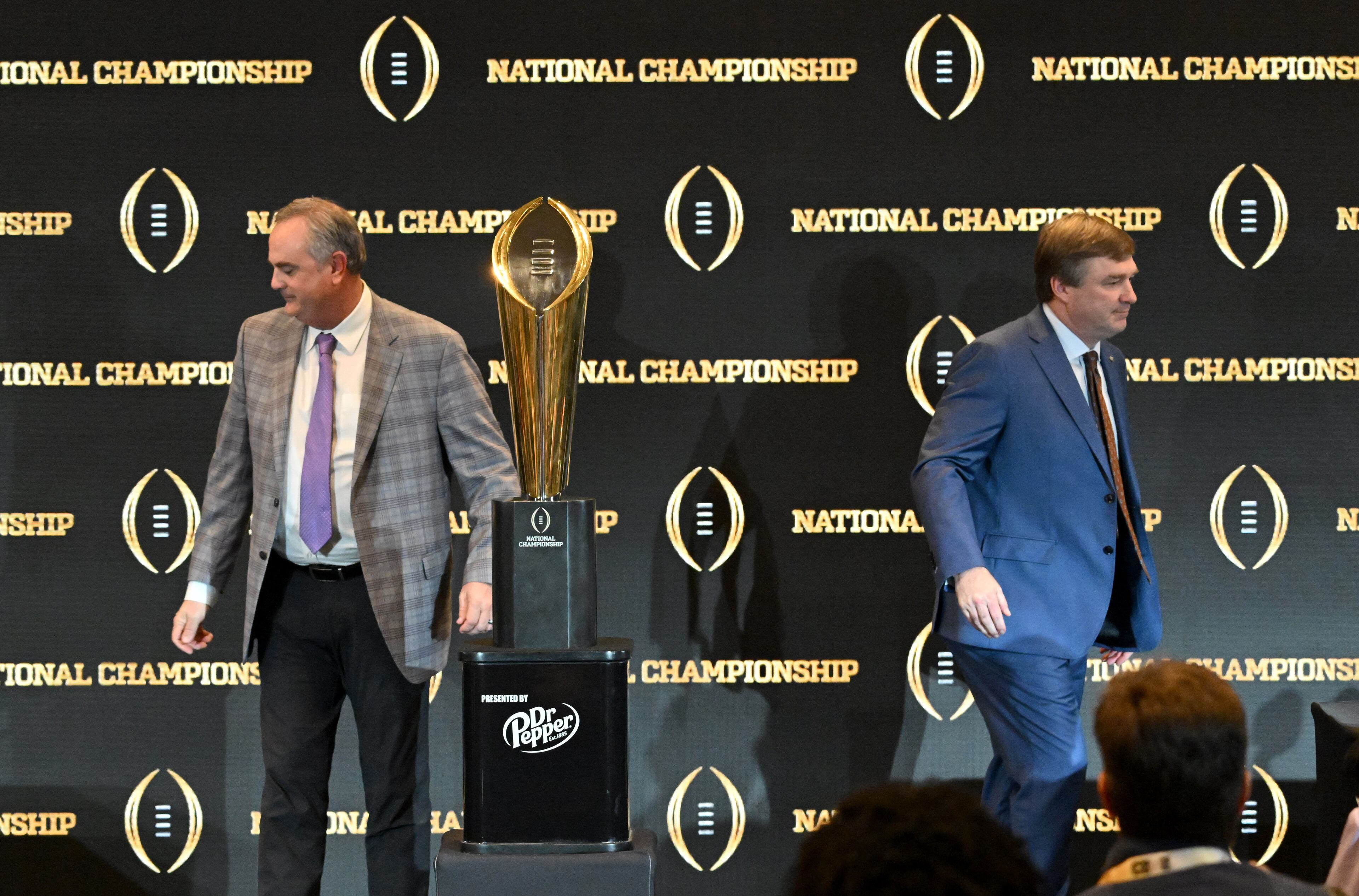 TCU coach Sonny Dykes (left) and Georgia coach Kirby Smart leave after the head coaches news conference Sunday in Los Angeles. (Hyosub Shin / Hyosub.Shin@ajc.com)