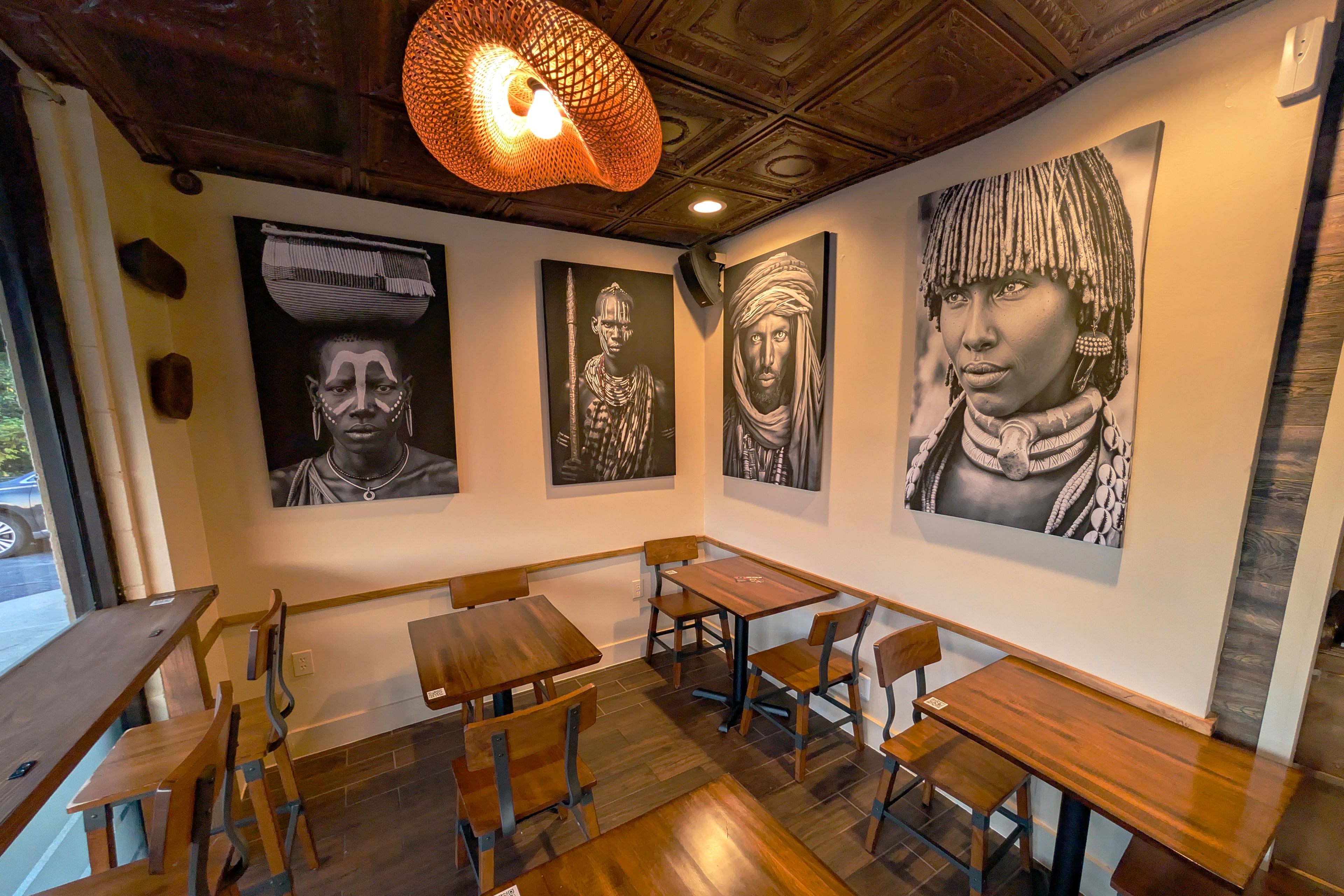 Coffee Therapy's interior includes a variety of cafe tables and booths and is decorated with large black and white portraits. (Courtesy of Coffee Therapy)