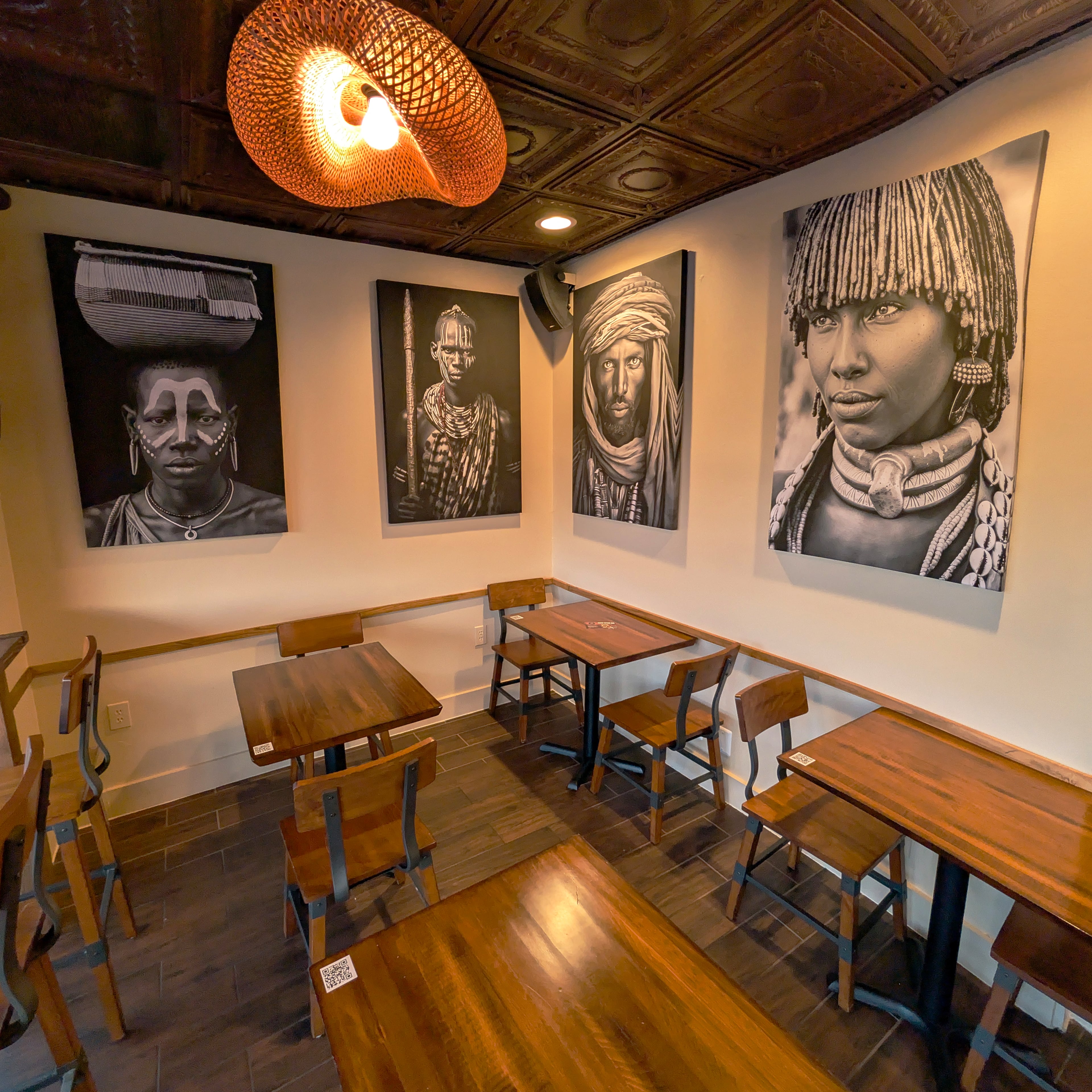 Coffee Therapy's interior includes a variety of cafe tables and booths and is decorated with large black and white portraits. (Courtesy of Coffee Therapy)
