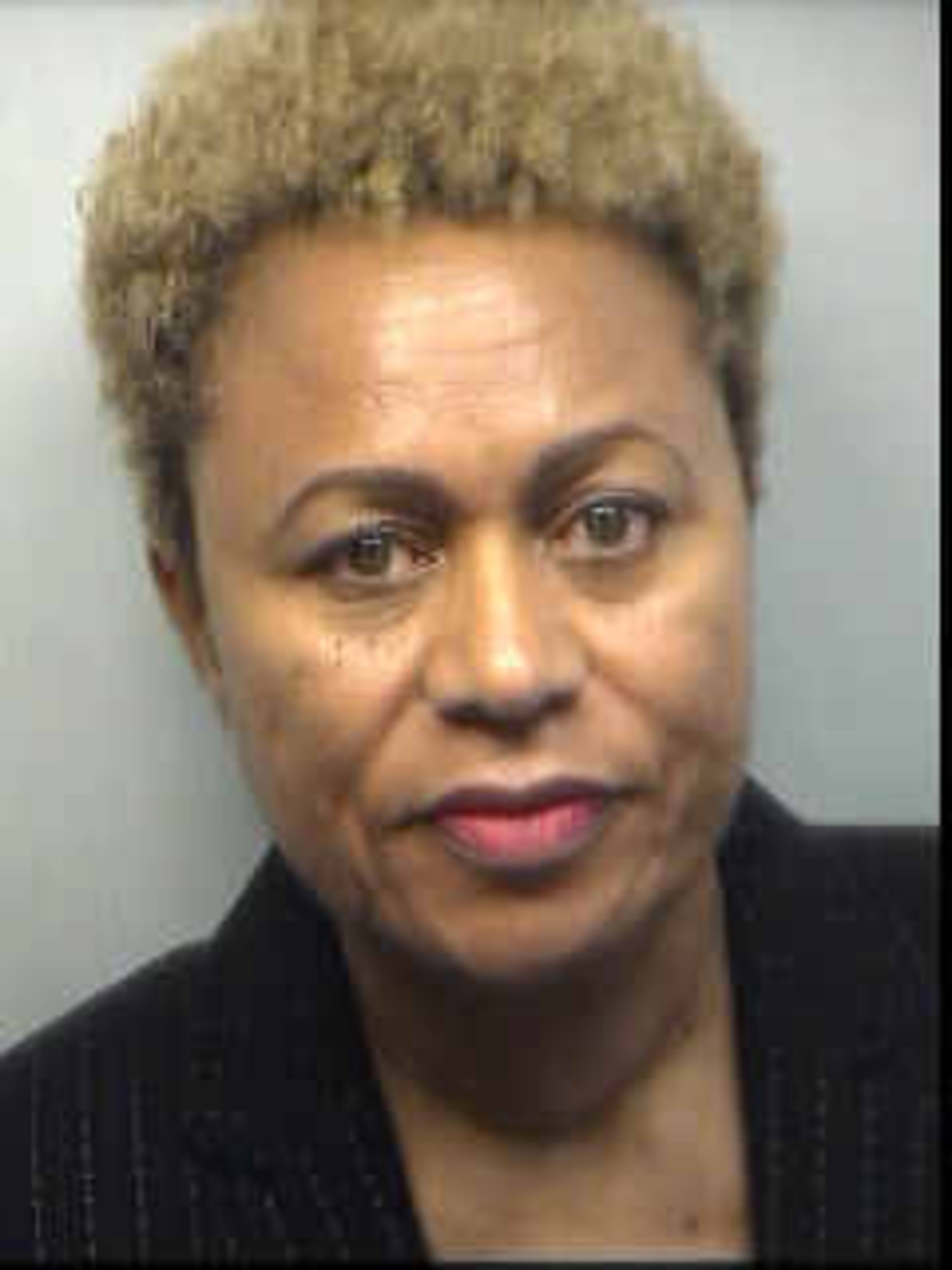 Sharon Davis-Williams, 57, area superintendent, was booked into the Fulton County Jail on $25,000 bond, according to jail records. She is charged with racketeering, false swearing, false statements and writing.