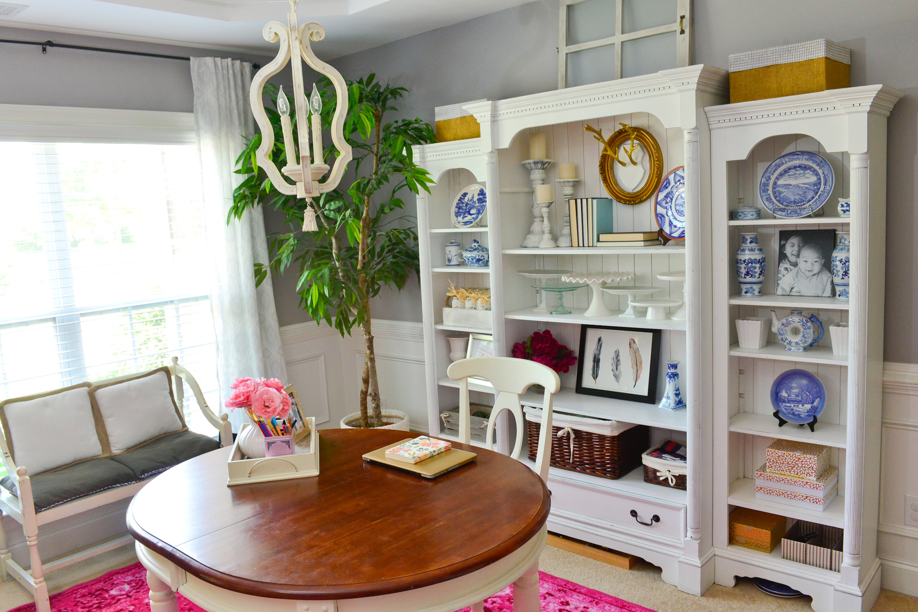 Office: Thrifted blue and white chinoiserie pieces, combined with the bright pop of pink in the rug, makes this dining room-turned-home office bright and colorful. The white bookshelves that form the focal point for the room came from homeowners Jimmy and Yuni Min's parents.