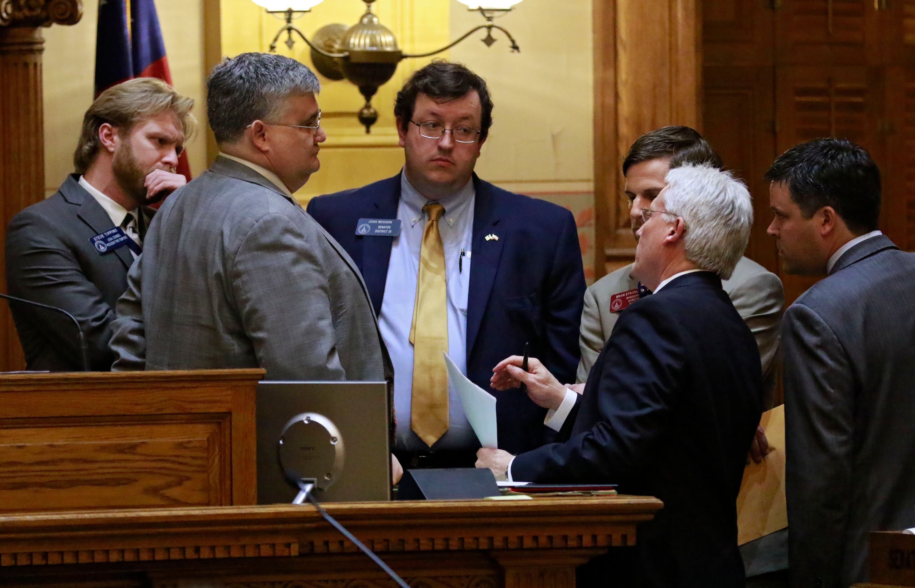 Mar. 24, 2016 - Atlanta - Senator Joshua McKoon (center) confers with Senate President David Shafer and others as HB 904 is sent back to conference committee. As this years general assembly comes to a close on the 40th day of the legislative session, legislators must consider scores of bills before the midnight deadline. BOB ANDRES / BANDRES@AJC.COM