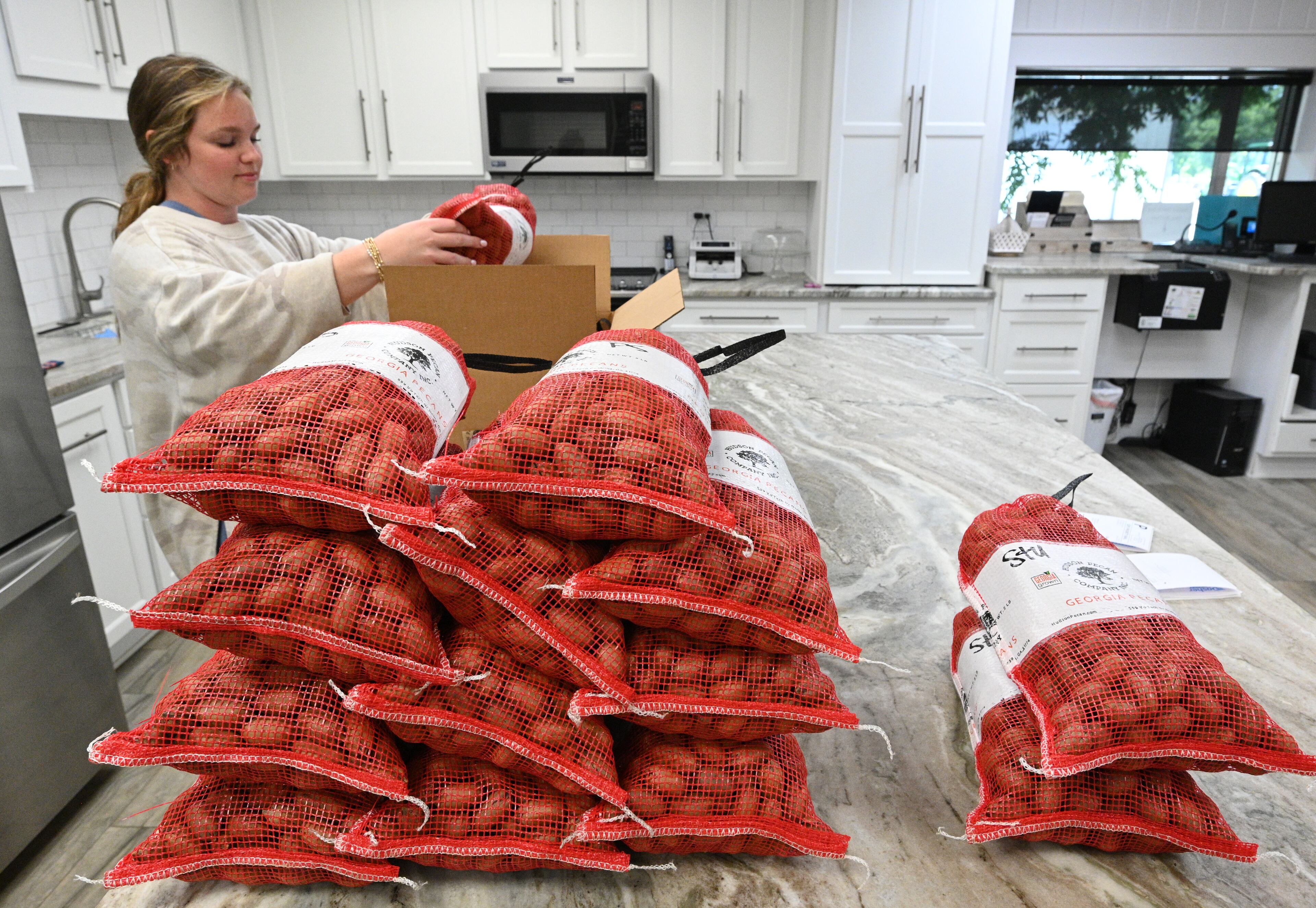 Reese Morgan is packing pecans to ship out at Hudson Pecan Company, Wednesday, June 28, 2023, in Ocilla, GA. Scott Hudson is president and CFO of Hudson Pecan Company in Ocilla, more than 180 miles southeast of Atlanta. The company has about 300 acres of pecan trees, and China is one of its biggest buyers. Before the pandemic, Hudson would visit the country two-to-three times a year, he said. (Hyosub Shin / Hyosub.Shin@ajc.com)
