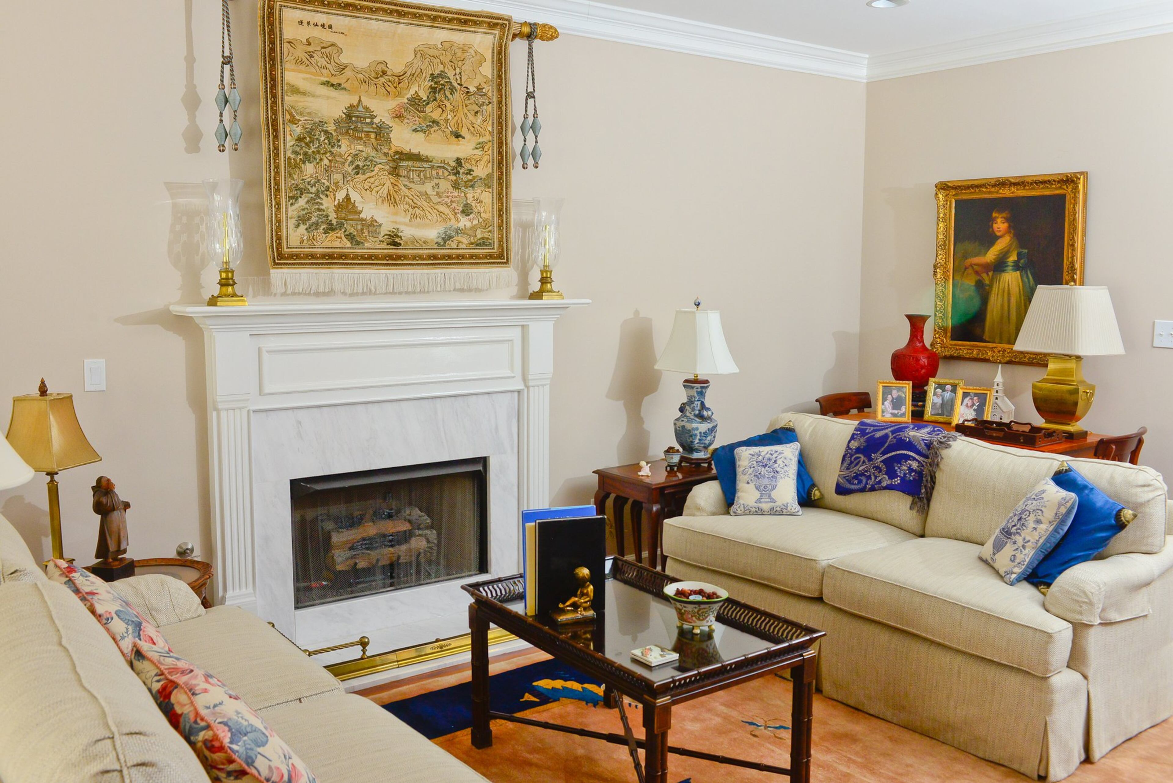 Chris and Linda Clark have filled their home with art that tells a story and reminds them of special people and places. The silk rug hanging over their fireplace, for instance, was a souvenir from a trip the couple made to China, while the portrait of a young girl over the living room sideboard was passed down from Chris' mother.