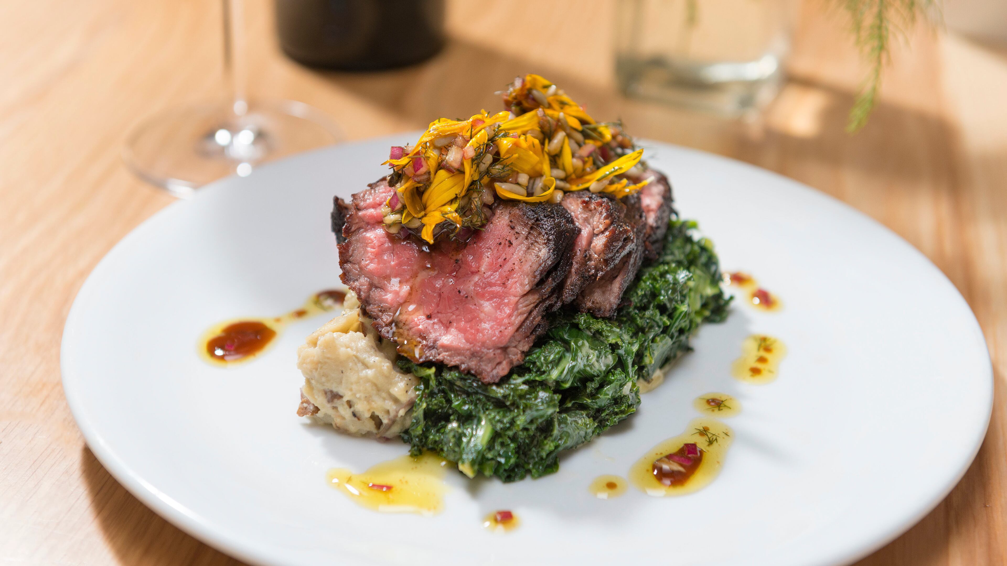 An undated handout photo of espresso cured grass-fed hanger steak, horseradish creamed kale and smoked sunchoke mash from Arbor, a restaurant in Chicago. Arbor, with an urban farm and part of a sustainable business hub, transcends being just another office building coffee shop.