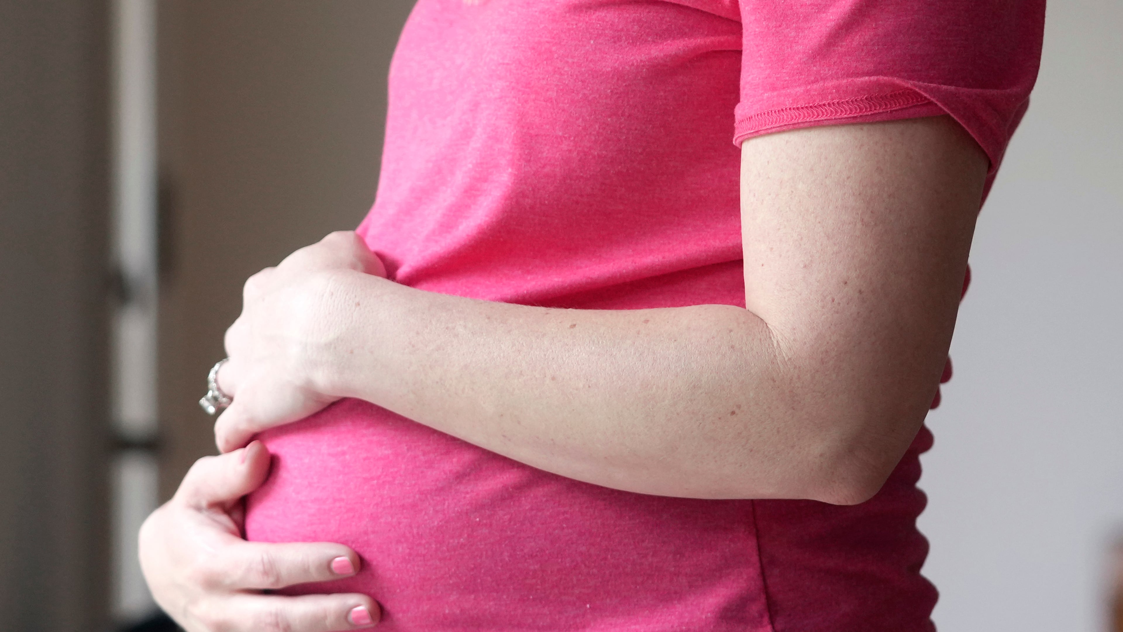FILE - A pregnant woman stands for a portrait in Dallas, May 18, 2023. (AP Photo/LM Otero, File)