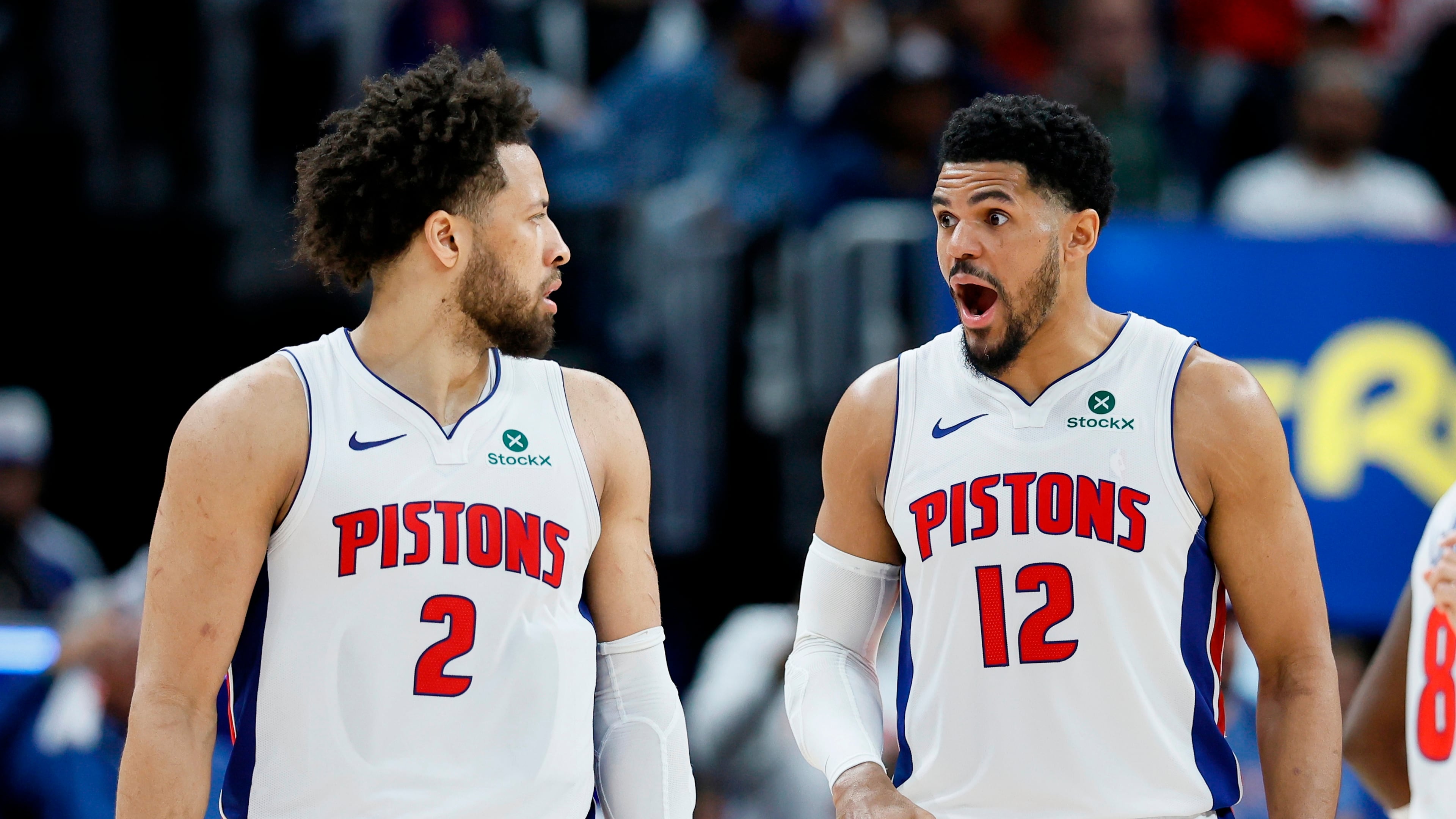 Detroit Pistons forward Tobias Harris (12) reads to a basket scored against the Orlando Magic by guard Cade Cunningham (2) during the second half in Game 5 of a first-round NBA basketball playoffs series Wednesday, April 29, 2026, in Detroit. (AP Photo/Duane Burleson)