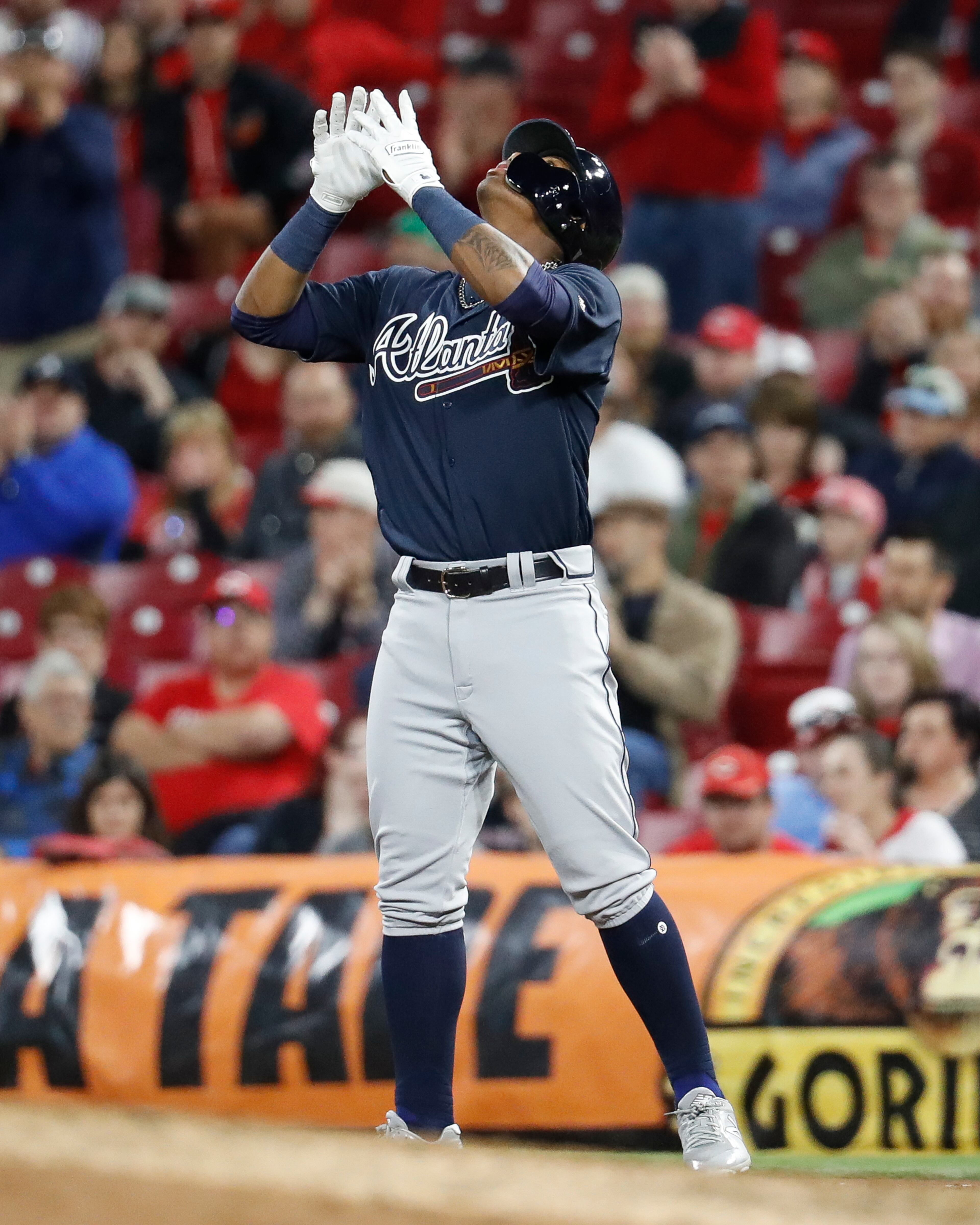 Atlanta Braves' Ronald Acuna Jr. celebrates after his first hit in the majors a single off Cincinnati Reds relief pitcher Kevin Shackelford during the eighth inning of a baseball game Wednesday, April 25, 2018, in Cincinnati. (AP Photo/John Minchillo)