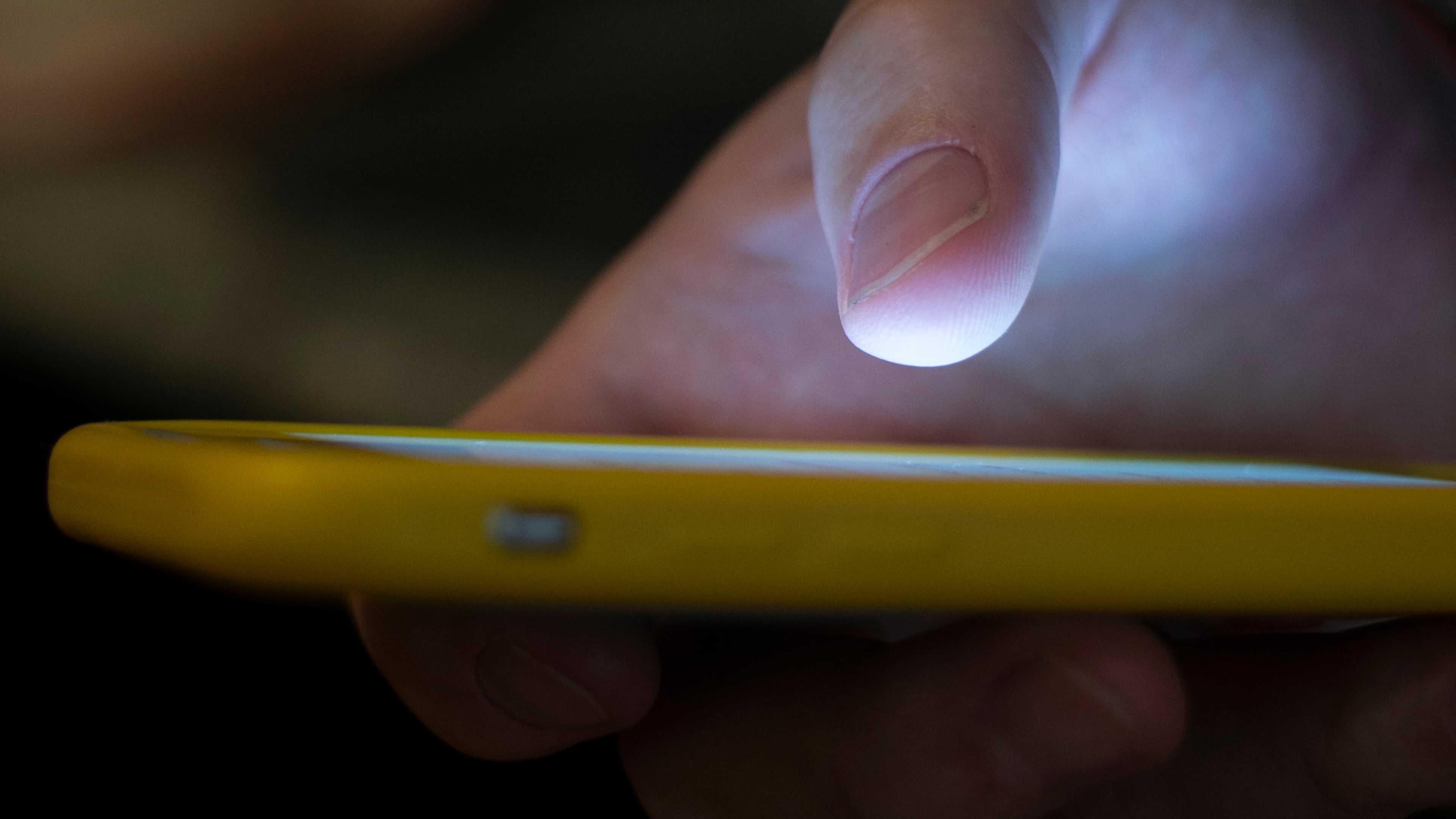 FILE - A man uses a cell phone in New Orleans on Aug. 11, 2019. (AP Photo/Jenny Kane, File)
