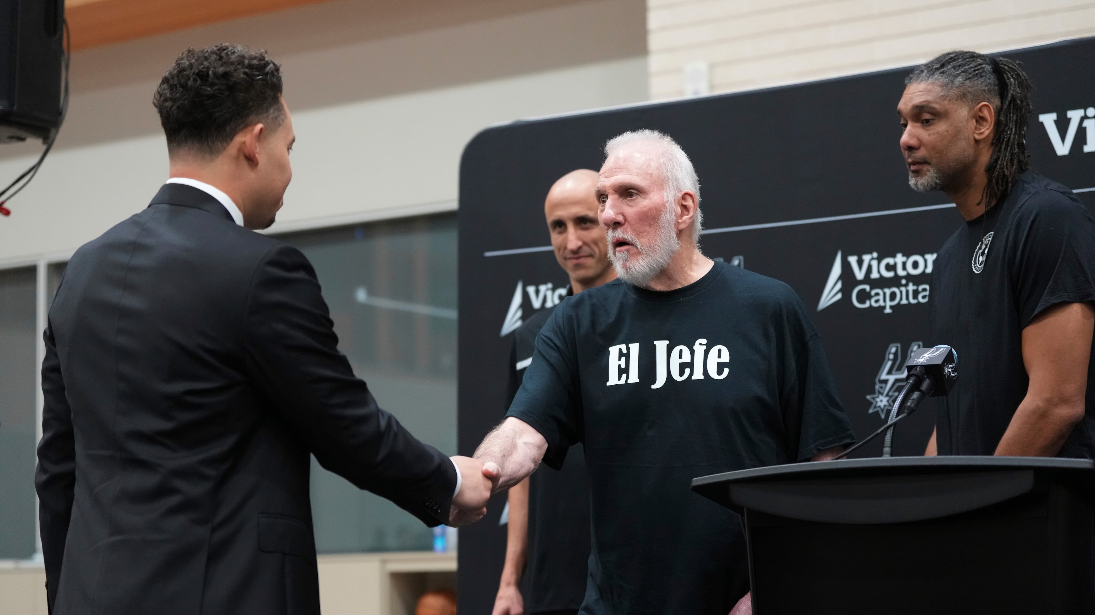 FILE - With the help of former players Manu Ginobili, back left, and Tim Duncan, right, former San Antonio Spurs head coach Gregg Popovich, center, introduces Mitch Johnson, left, as the new head coach of the San Antonio Spurs NBA basketball team, in San Antonio, May 5, 2025. (AP Photo/Eric Gay, File)